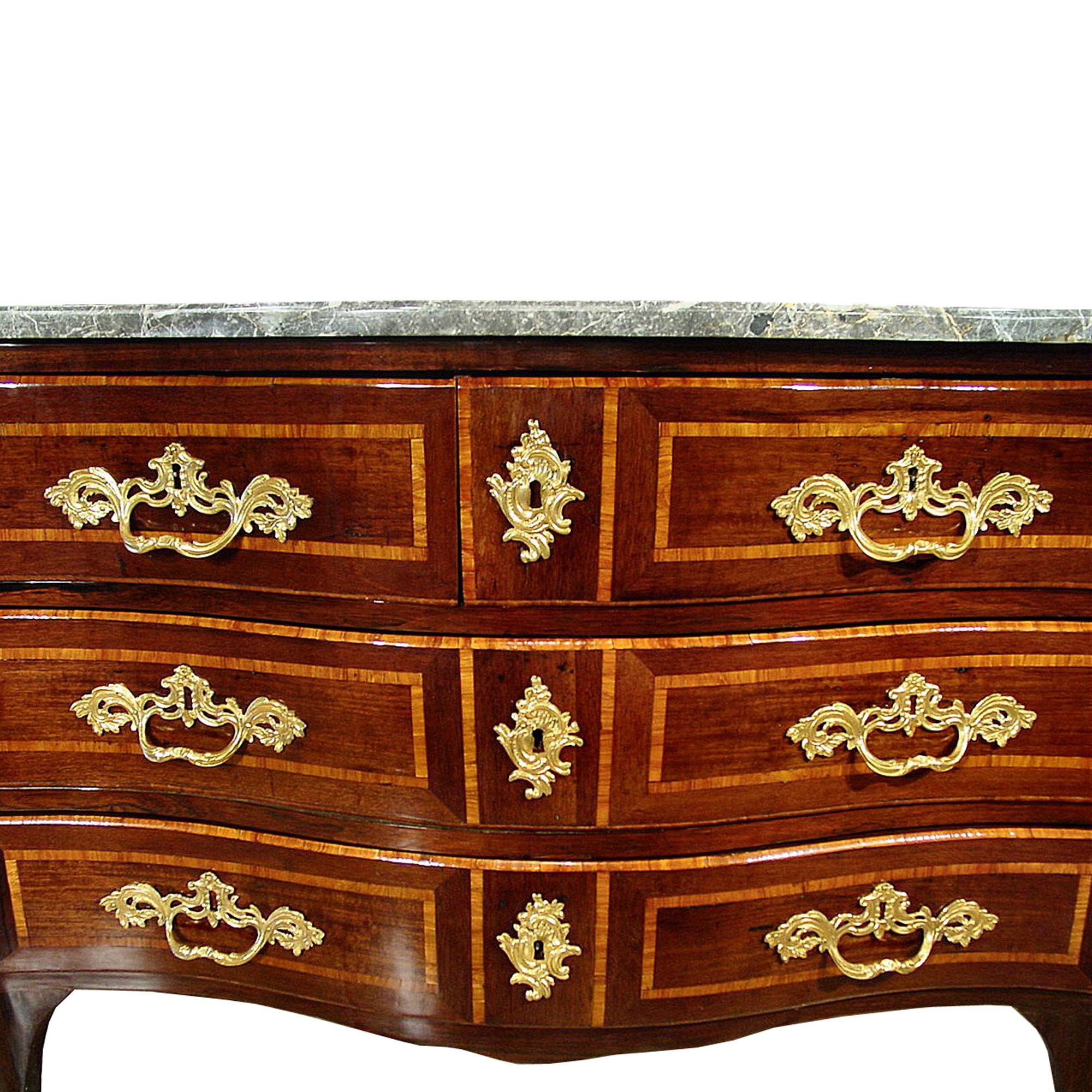 An elegant French mid 18th century Regence period kingwood commode stamped JME, 'Lardin'. The chest has three wide drawers with very impressive finely chased ormolu handles centered by ormolu keyhole escutcheons. The drawers and sides are bordered