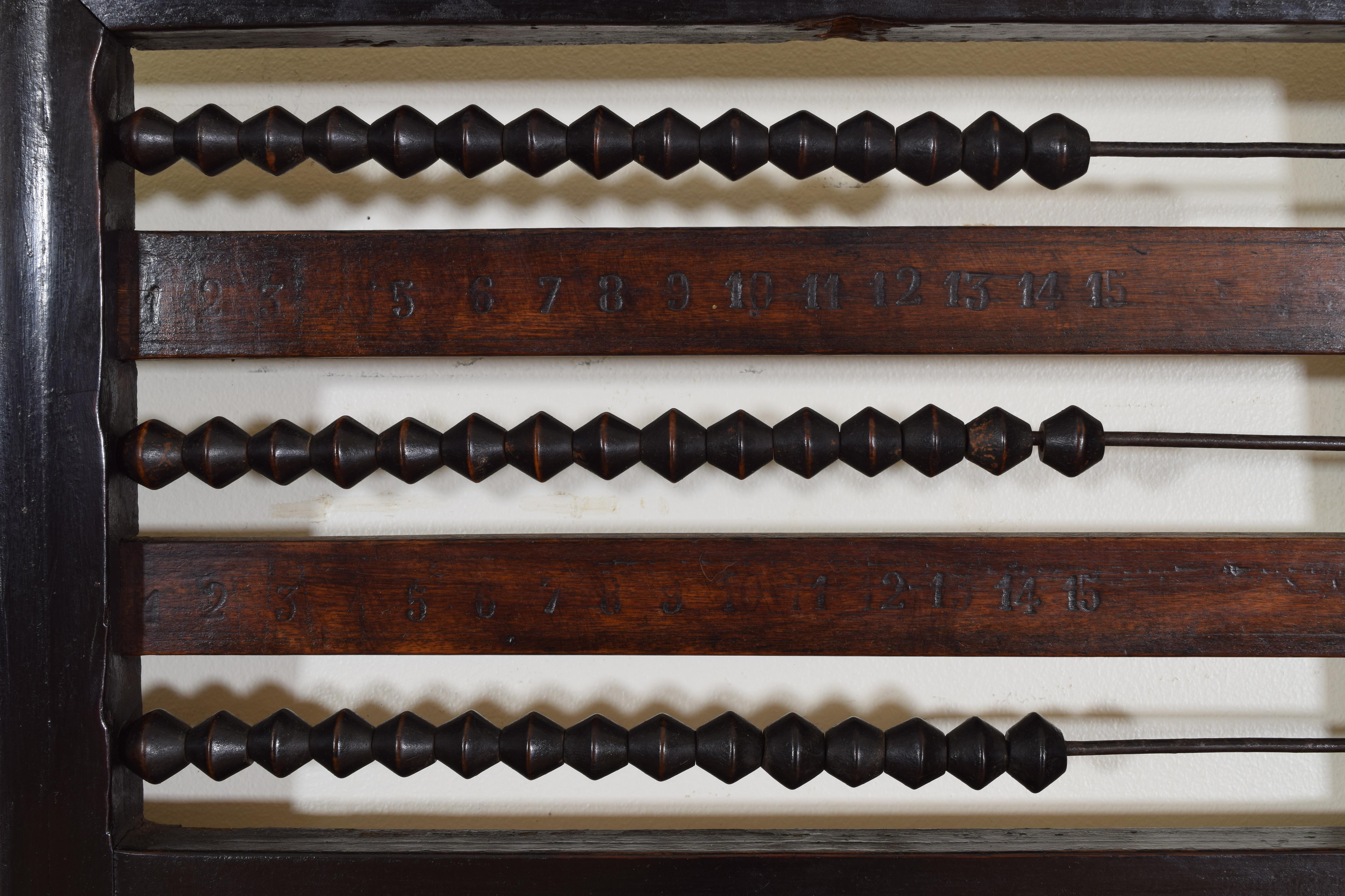 Having a molded edge frame of ebonized walnut, the upper portion a working three part abacus with engraved numbers, the lower section awaiting a mirrorplate of choice.