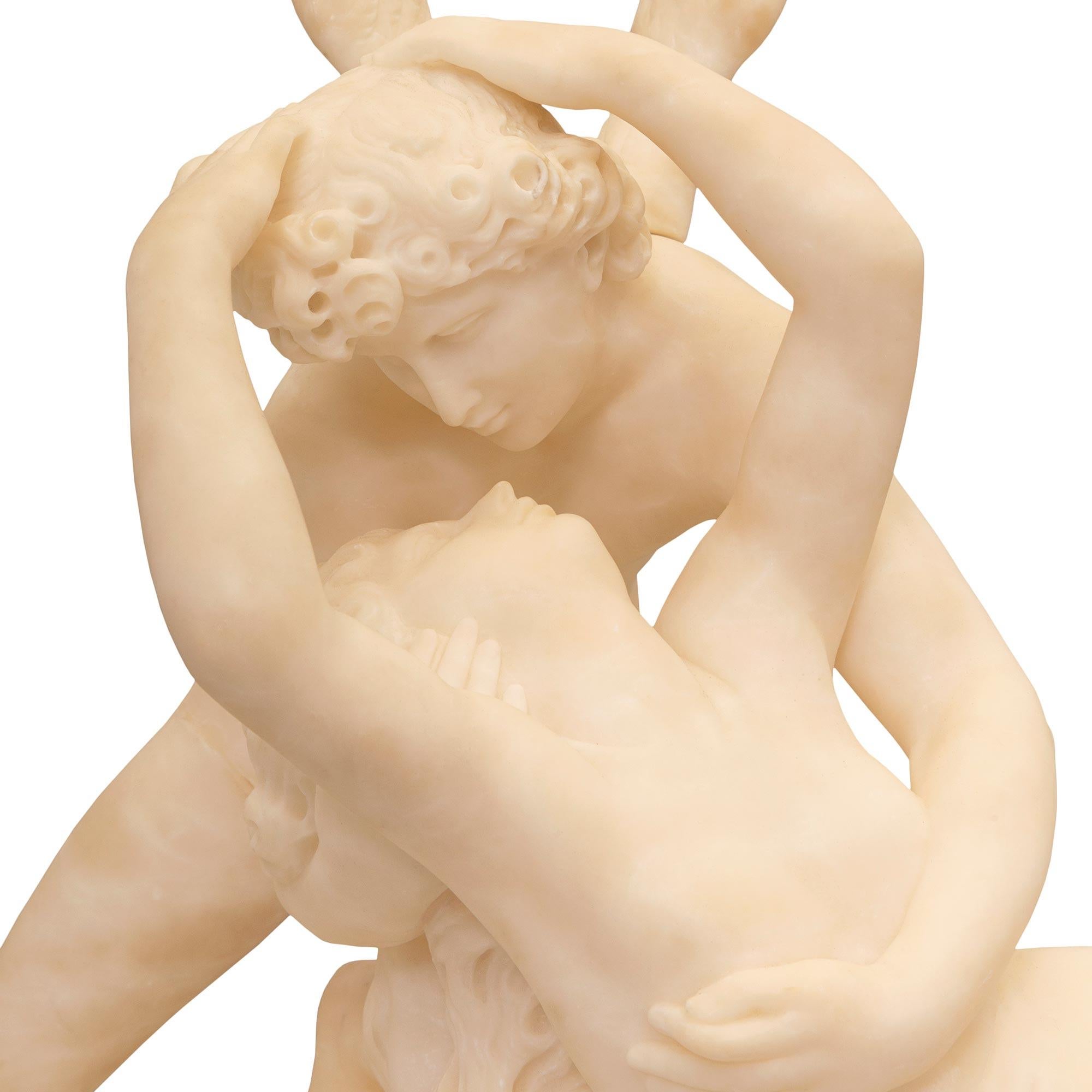 A stunning and extremely high quality French mid 19th century Alabaster statue of Cupid and Psyche. The statue after a model by Antonio Canova is raised by a wonderfully executed ground designed base where Cupid is reviving Psyche who was put to