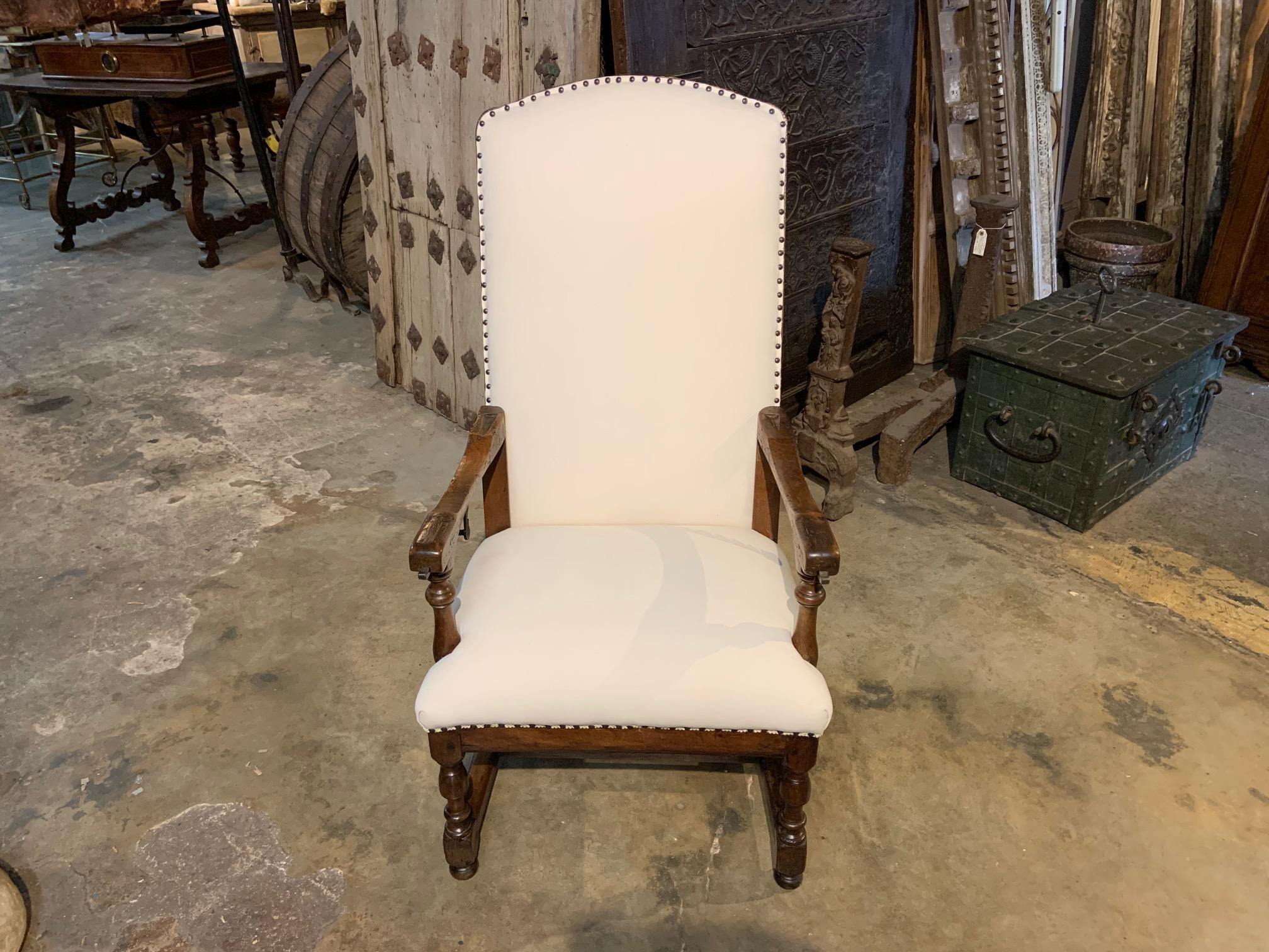 A very handsome 18th century mechanical Chaise De Repos from the South of France. Soundly crafted from walnut, this chair is constructed with the Cremaillere system - for reclining. There are also iron pullouts recessed in the arms for supporting a