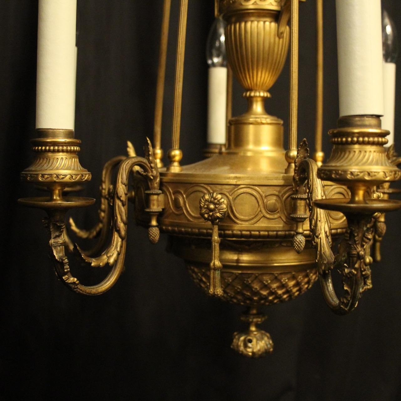 A quality French gilded bronze 6-light antique chandelier, the leaf clad scrolling arms with ornate circular bobeche drip pans and reeded twisted candle sconces, issuing from an ornate band with central reeded urn and set below with lovely lattice