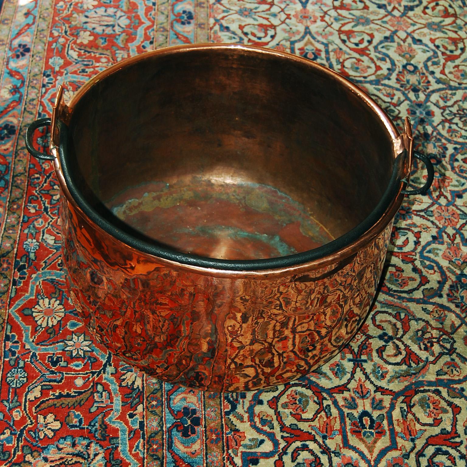 
 French copper 19th century cauldron with iron swing handle and dovetailed construction.  This large heavy gauge cauldron makes a wonderful log bin or planter or storage place for toys or other paraphernalia.   Circa 1850.    19 1/2