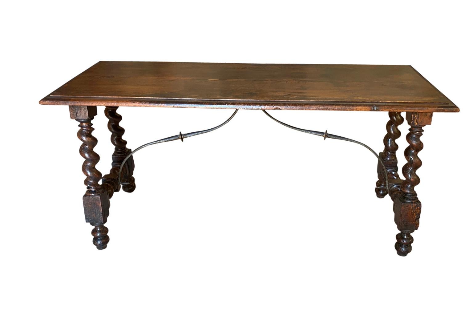 A very handsome mid-19th century Louis XIII style console table constructed from walnut and richly stained pine with beautifully turned legs, iron stretchers and a lovely edge finish to the top.