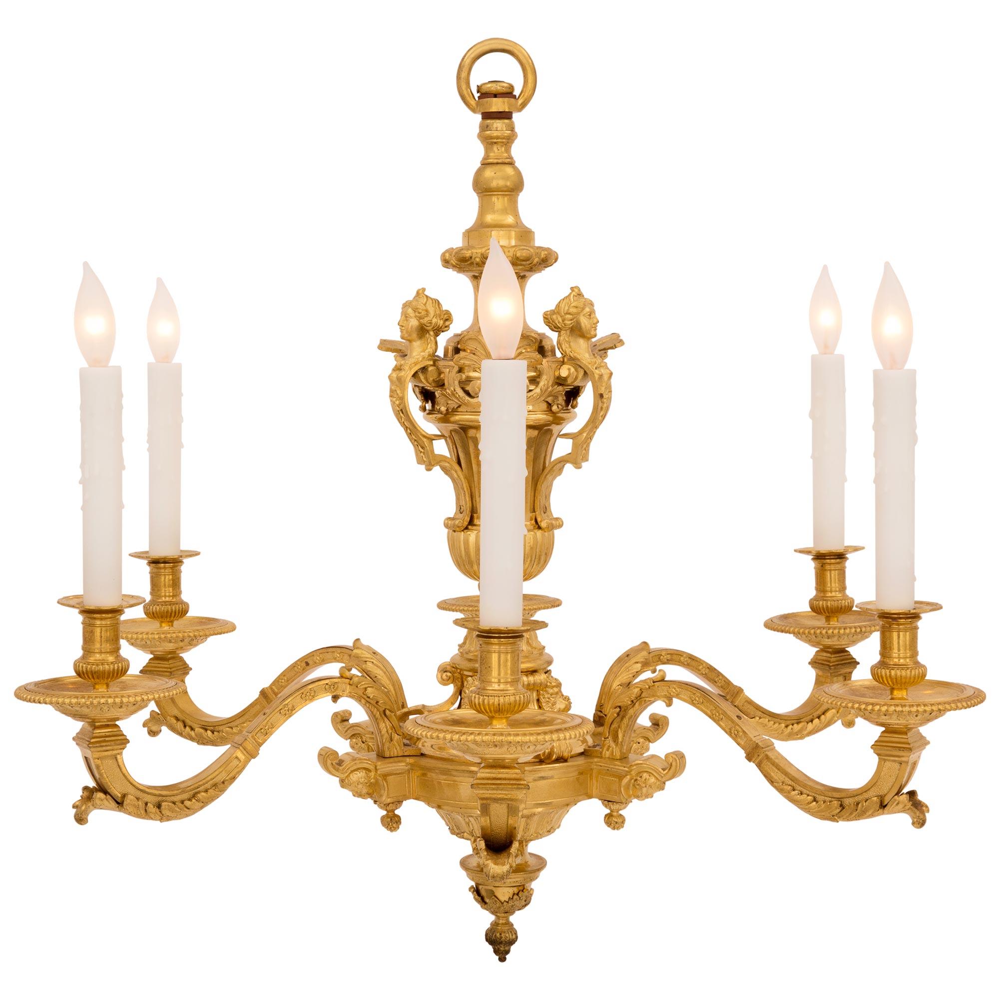 A most handsome French 19th century Louis XVI st. ormolu chandelier. The eight arm chandelier is centered by a lovely bottom acorn finial below fine foliate mounts with a mottled and reeded design centered by a charming acorn finial. Each of the