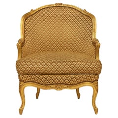 Poltrona Bergère francese della metà del XIX secolo in legno di gilt, stile Luigi XV