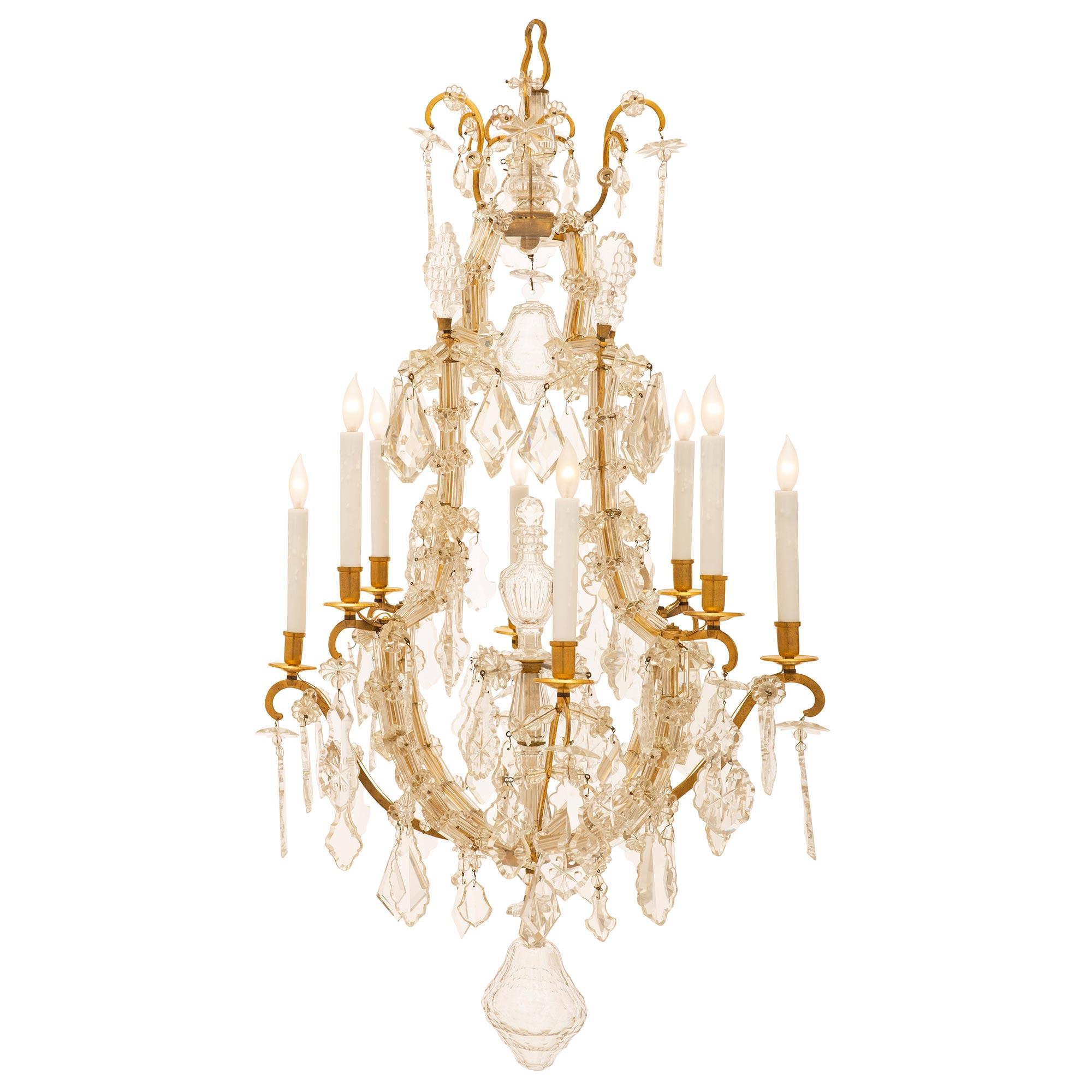 A very elegant and extremely high quality French mid 19th century Louis XV st. ormolu and Baccarat crystal chandelier. The eight arm chandelier has an open cage and a central crystal fut with a top perfume bottle design under a hanging cut crystal