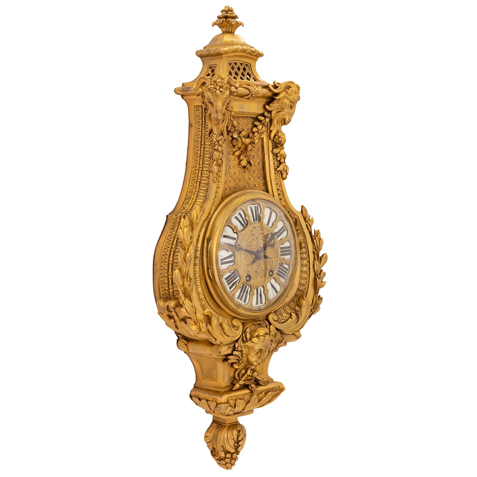 An exceptional and very high quality French mid 19th century Louis XVI st. ormolu cartel clock, by Etienne Maxant. The impressive wall clock is centered by a stunning richly chased bottom berried foliate finial below an intricately detailed mask of