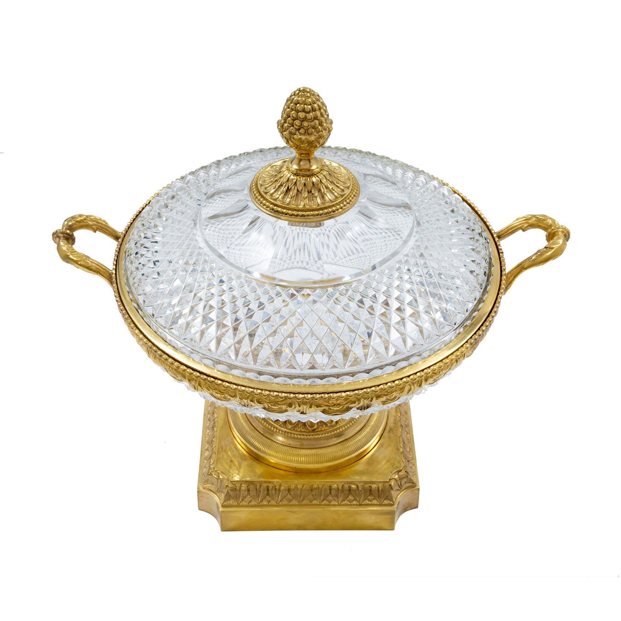 A spectacular French mid-19th century Louis XVI st. Baccarat crystal and ormolu centerpiece. The centerpiece is raised by a square and mottled ormolu base with concaved corners and a richly chased moulded border above. The circular moulded support