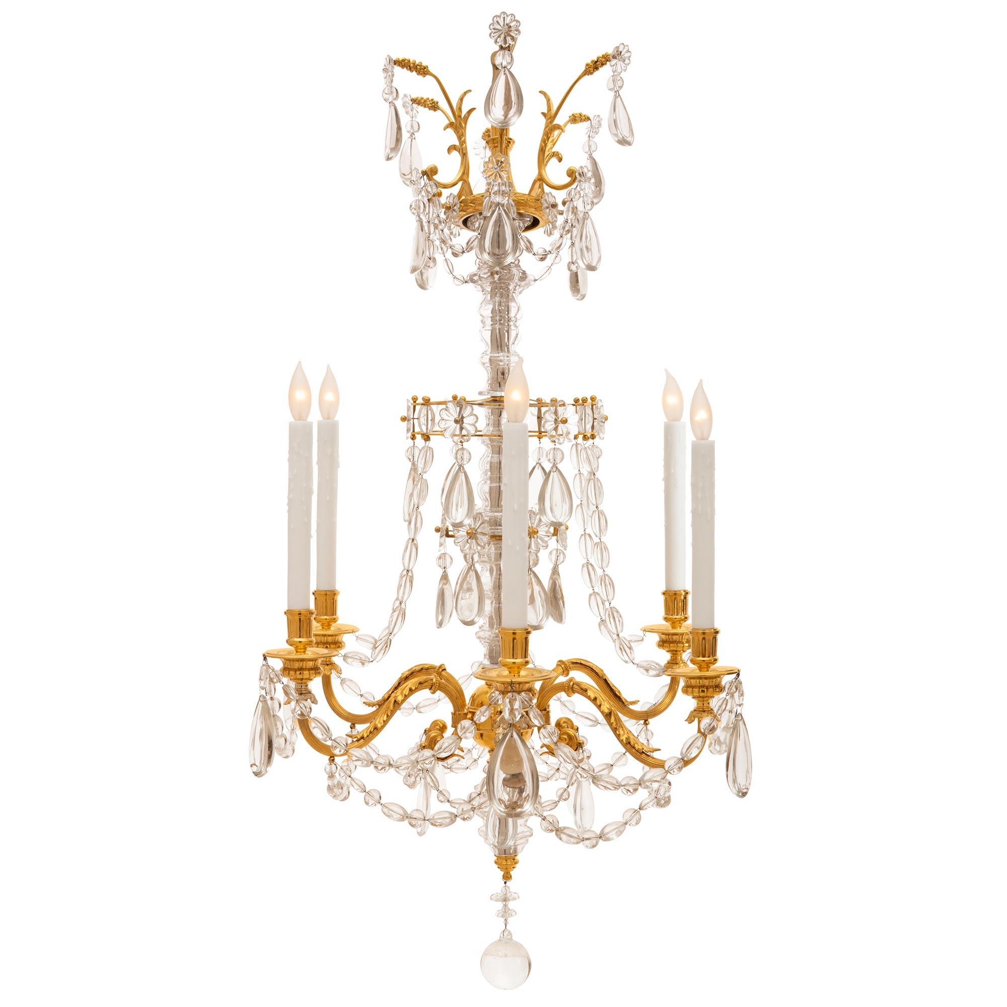 A very elegant French mid 19th century Louis XVI st. Marie Antoinette Baccarat crystal chandelier. With six S scrolled ormolu arms joined by crystal garlands accented with tear drop crystal pendants at each finely chased bobeches. All above a