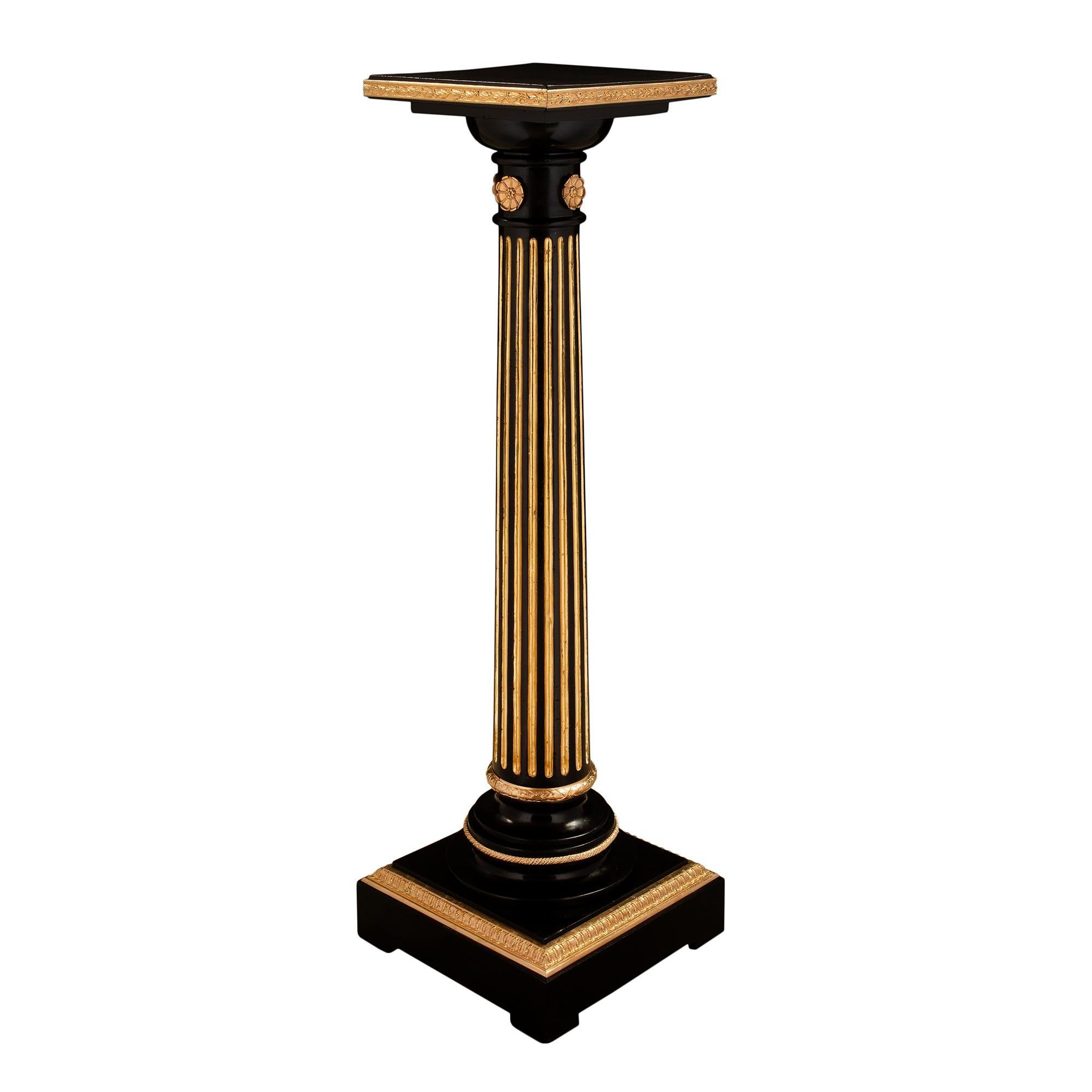 A handsome French mid-19th century Louis XVI st. ebony, giltwood and ormolu mounted pedestal. The pedestal is raised by a square ebony base with a richly chased Coeur de Rai designed ormolu band. Above is a circular socle with two ormolu bands. The