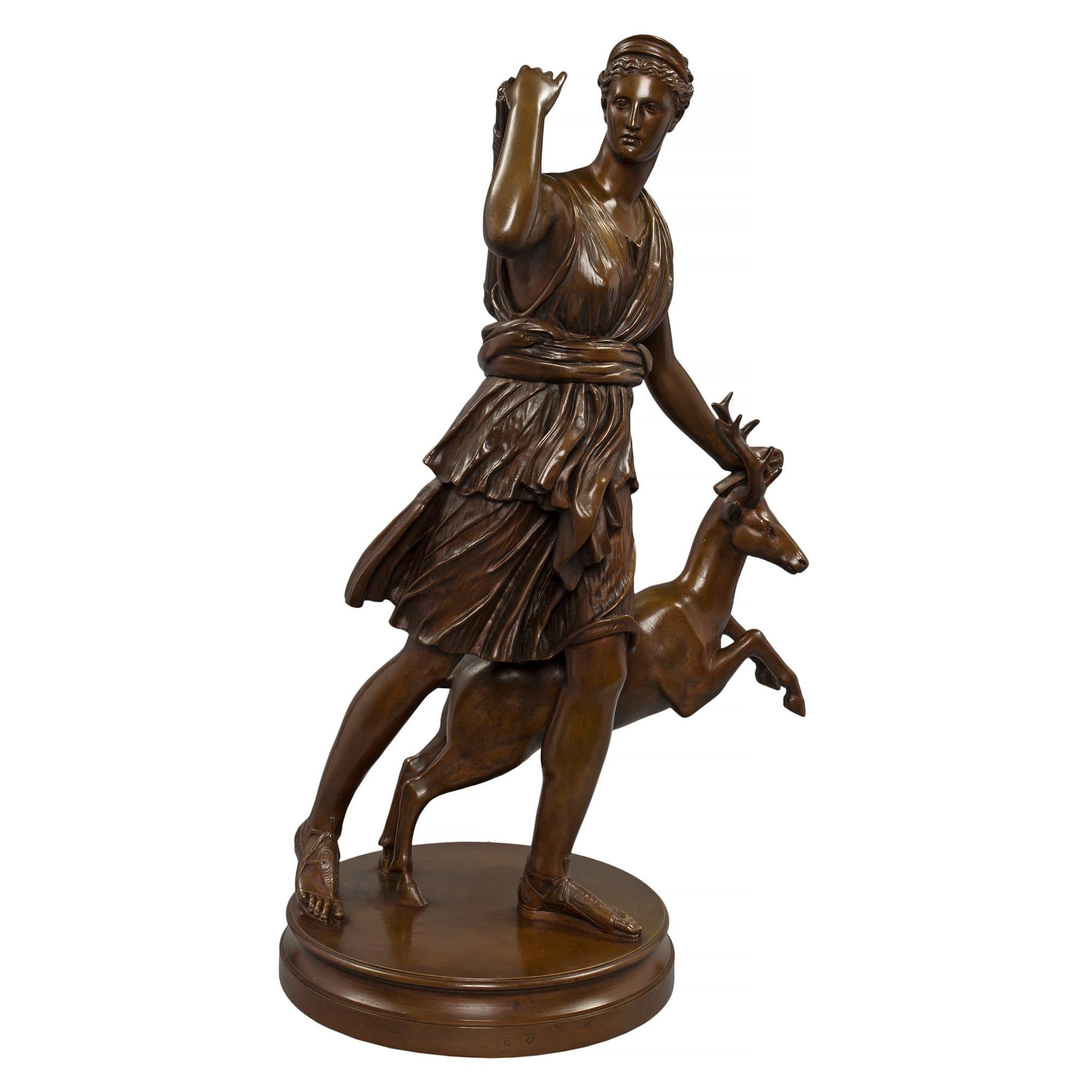 A sensational and large scale French mid 19th century Louis XVI st. patinated bronze statue of Diana the Huntress, signed by Barbedienne. Diana dressed in classical attire and is reaching behind her shoulder to get a bow out her quiver.Her other