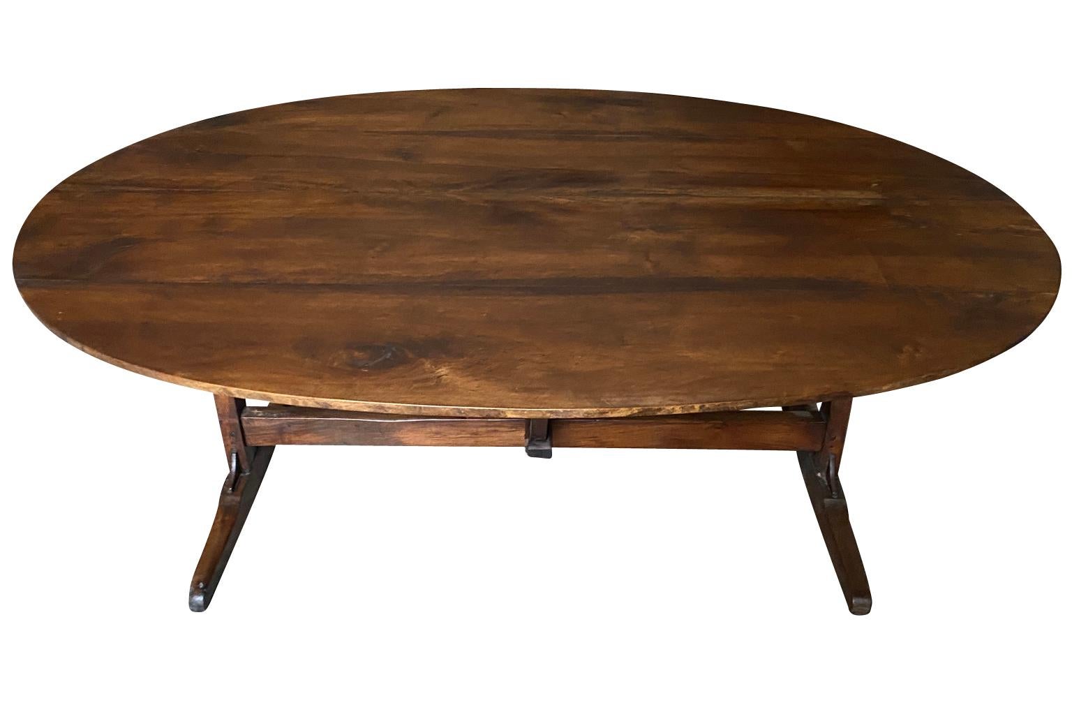 A very handsome mid-19th century oval shaped Wine Tasting Table - Table Vigneron - from the Provence region of France.  Beautifully constructed from handsome walnut with a tilting top.  Perfect as a relaxed dining table.  Wonderful patina.