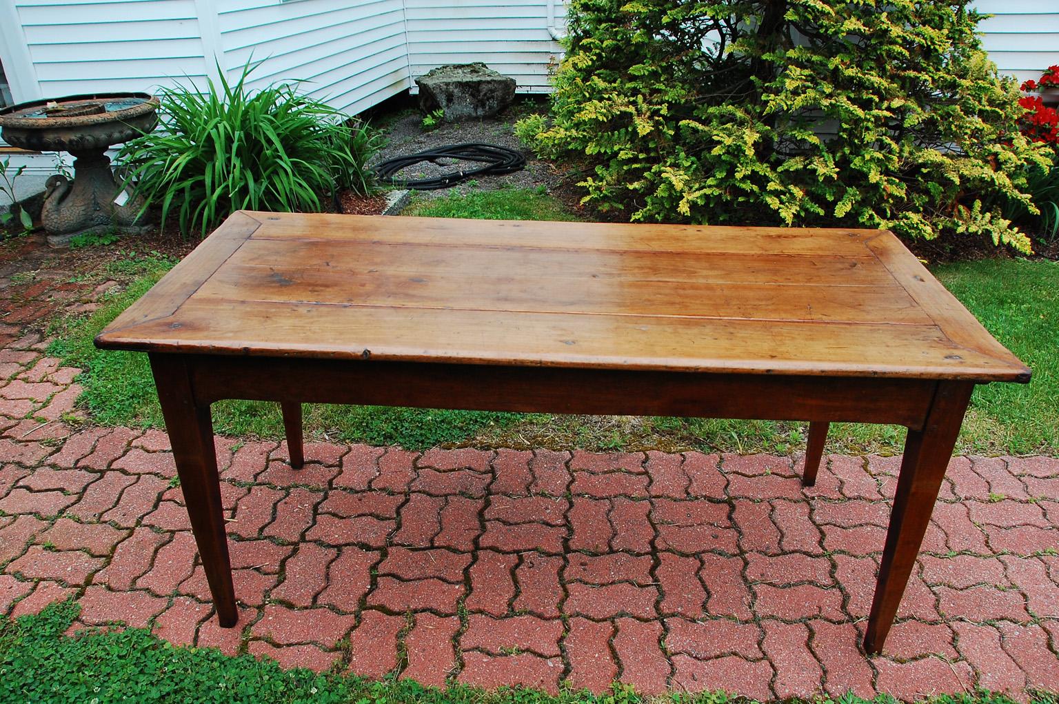 French provincial cherry farmhouse table , sixty six inches long, with tapered legs, one drawer and slide out chestnut bread slide.  The twenty nine inch long bread slide can be used as additional serving space, or slicing bread during the meal, or