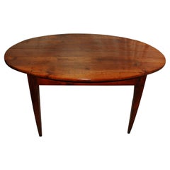 French Mid-19th Century Provincial Cherry Oval Dining Table with Tapered Legs