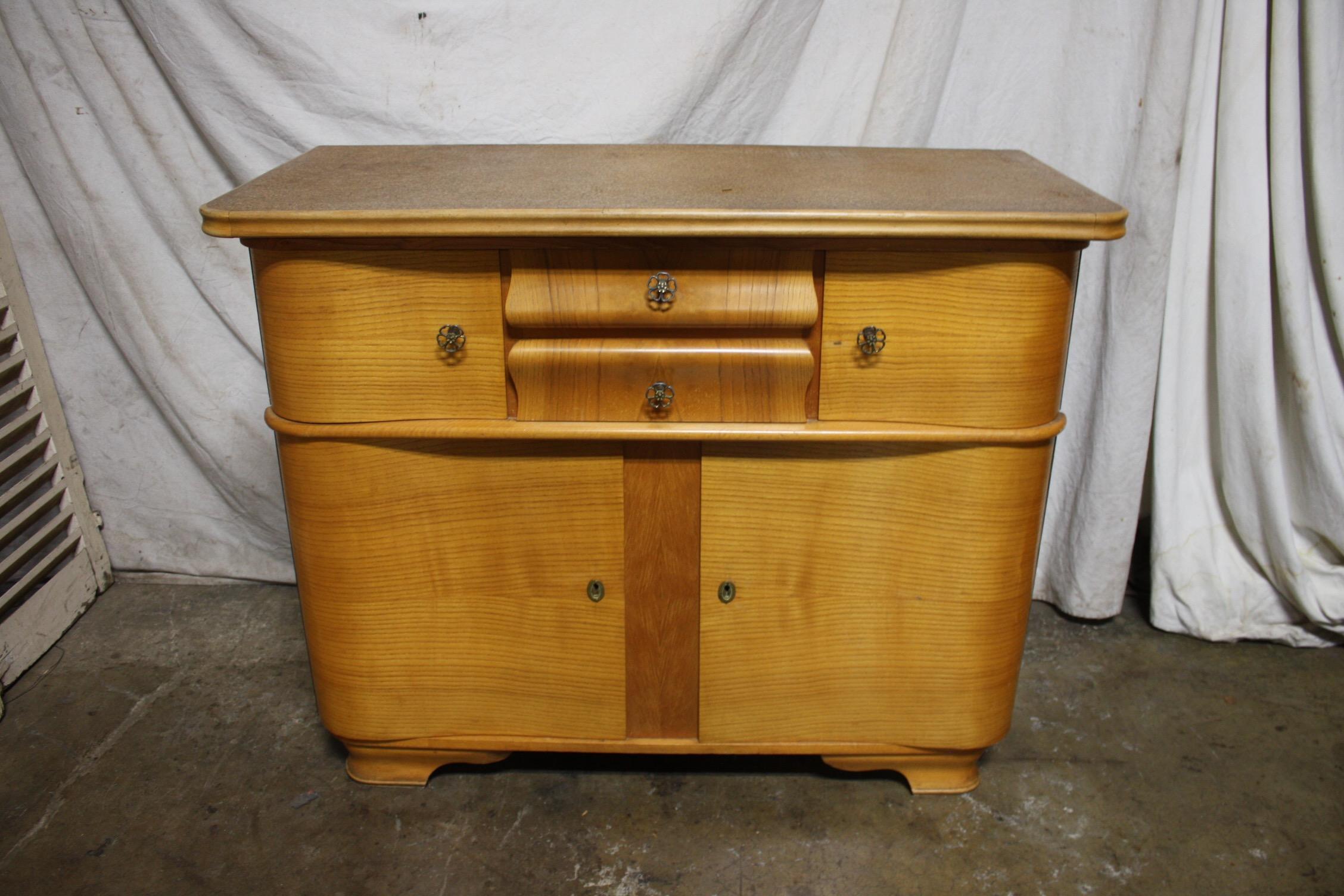 Really nice line and curve on this buffet. Beautiful wood and an interesting top too.