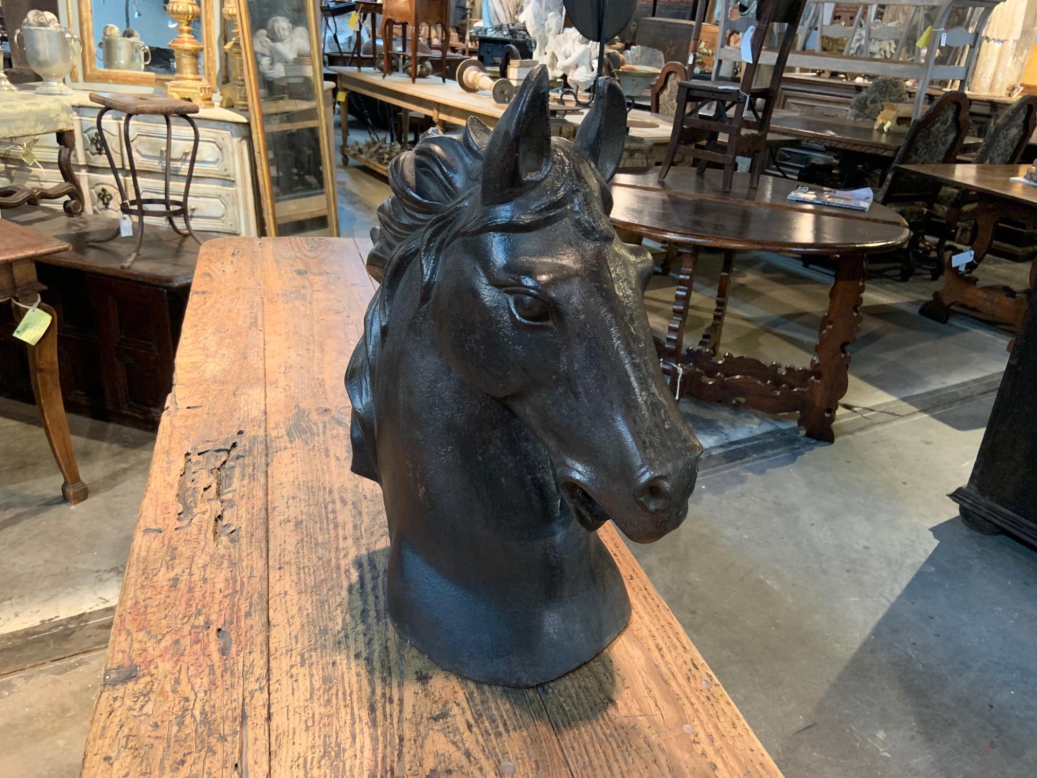 A very impressive French mid-20th century horsehead sculpture beautifully cast in patinated iron. Terrific accent piece for any bookcase, mantel, tabletop or garden accent.