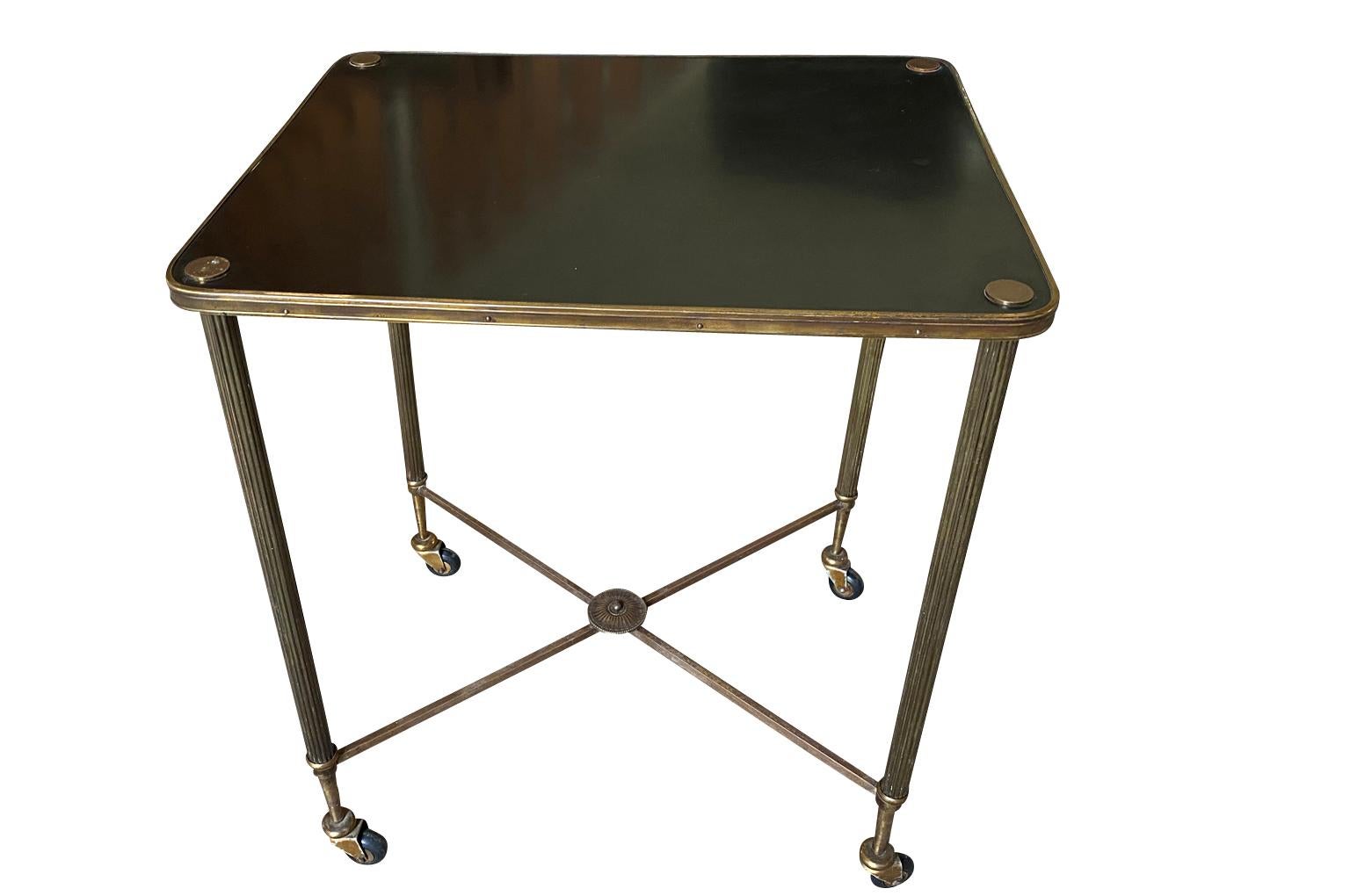 A stunning mid-20th century Drinks Table - Cocktail Table in the Maison Jansen taste.  Soundly constructed from brass.  An elegant accent piece.