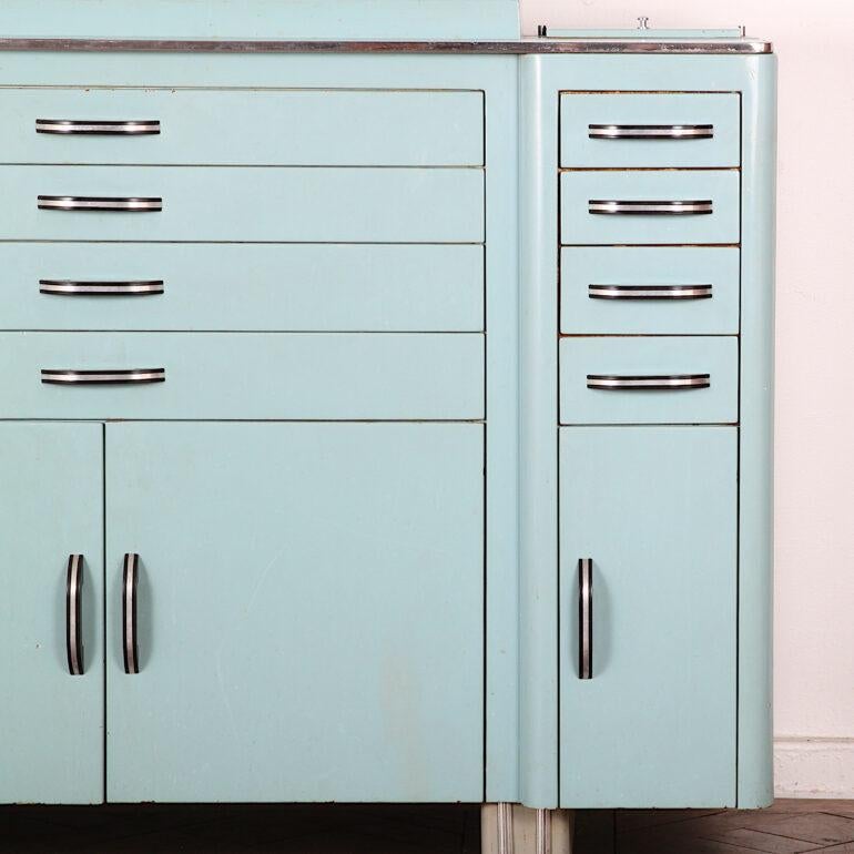 French 1950s blue enamel cabinet with twelve smaller glass-bottomed drawers above four-door cabinet space below.

 