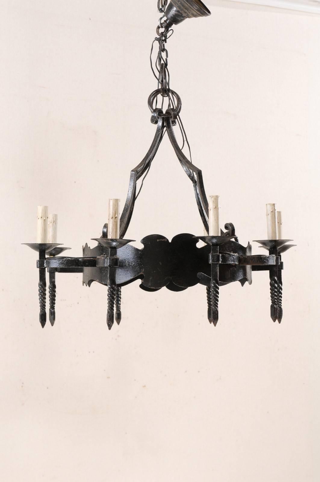 Forged French Mid-20th Century Iron Ring Chandelier with Eight Torch-Shaped Lights For Sale