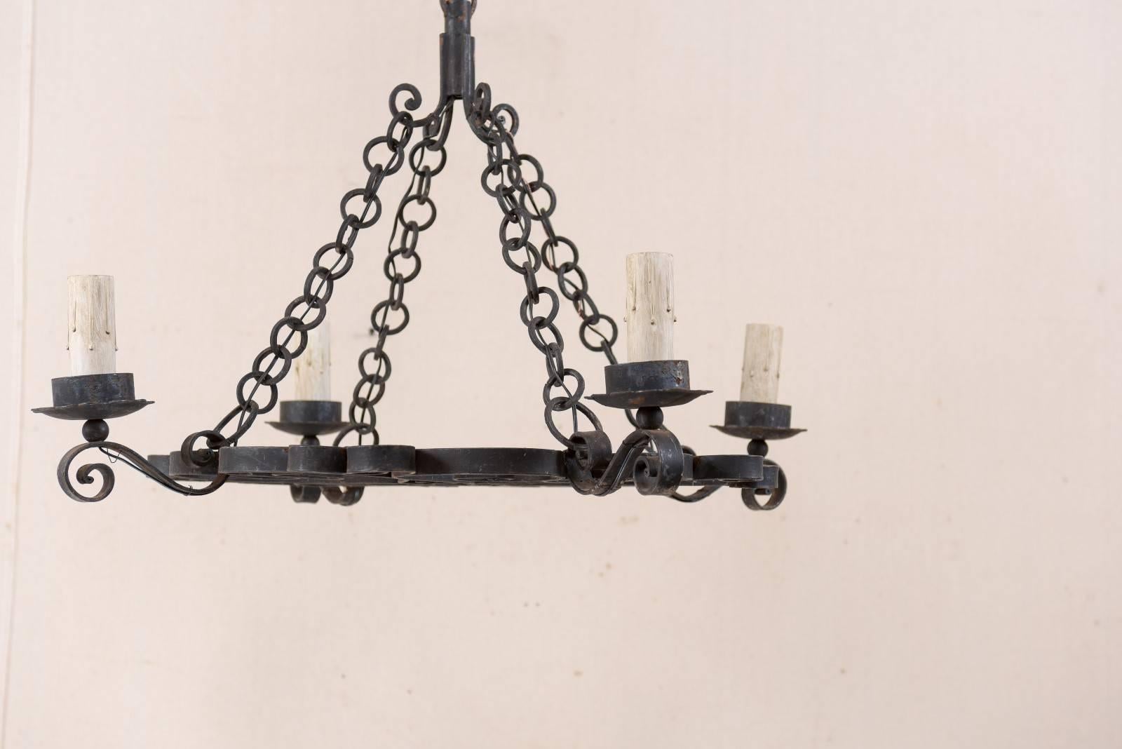 Forged French Mid-20th Century Nicely Scrolled Four-Light Black Iron Chandelier For Sale