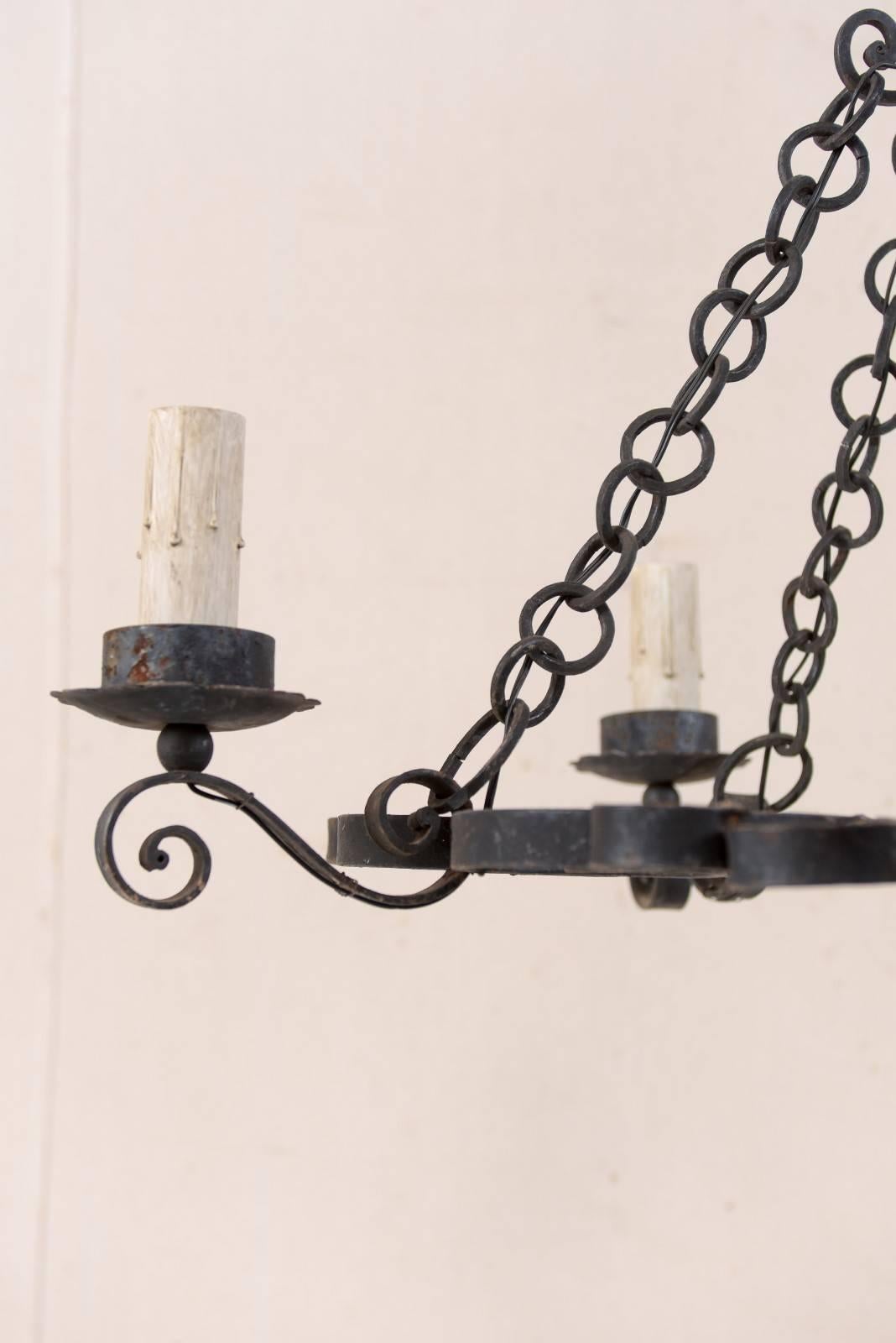 Metal French Mid-20th Century Nicely Scrolled Four-Light Black Iron Chandelier For Sale