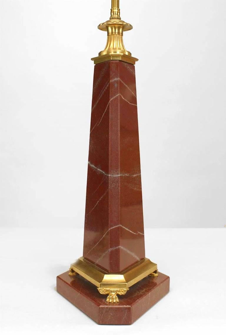 French (mid-20th Century) rouge marble table lamp of obelisk shape supported on a bronze dore trim base with claw feet.
