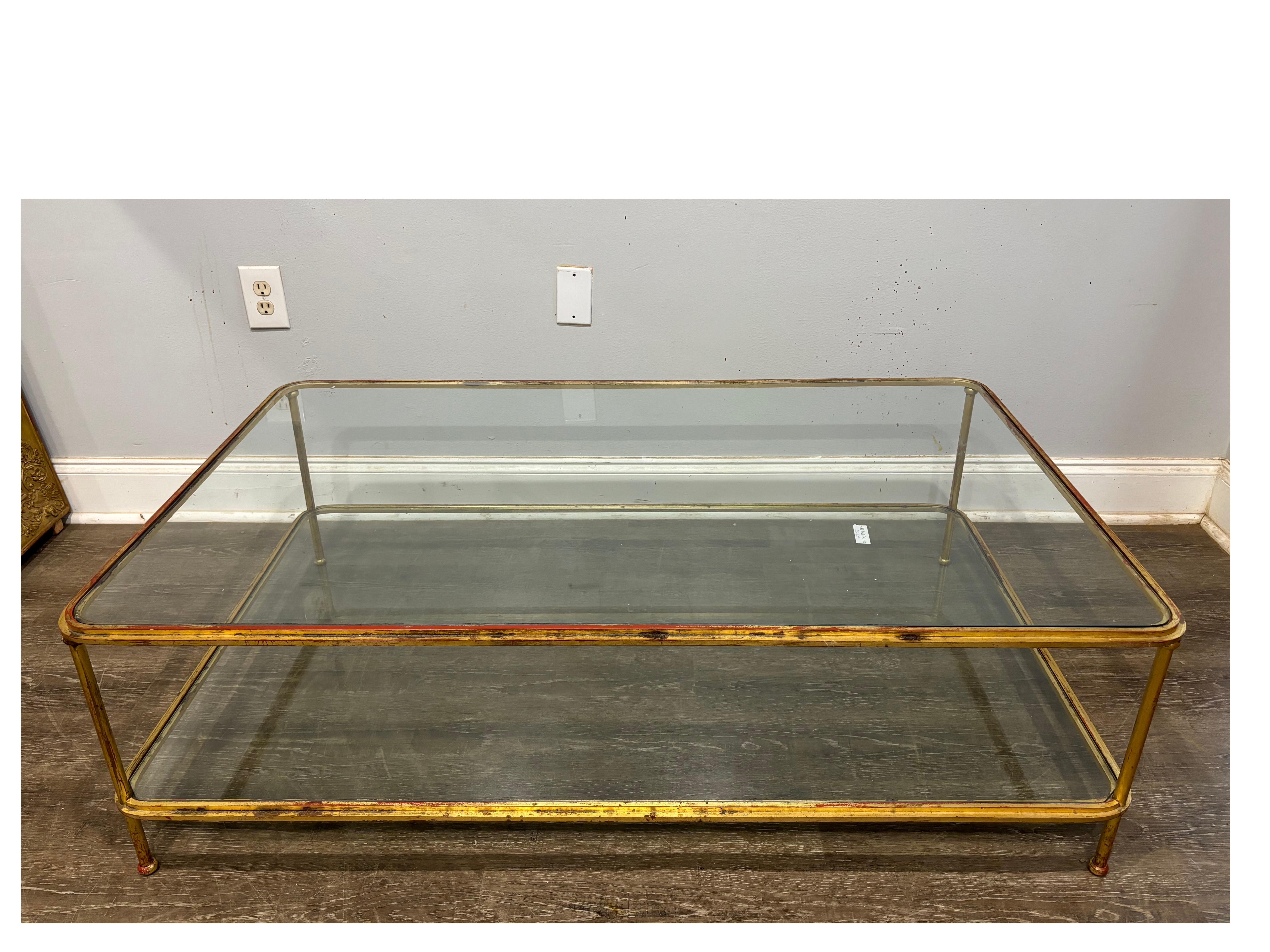 This Table is in metal covered with a gold leaf  with a red layer under. Very nice scale, long and low.