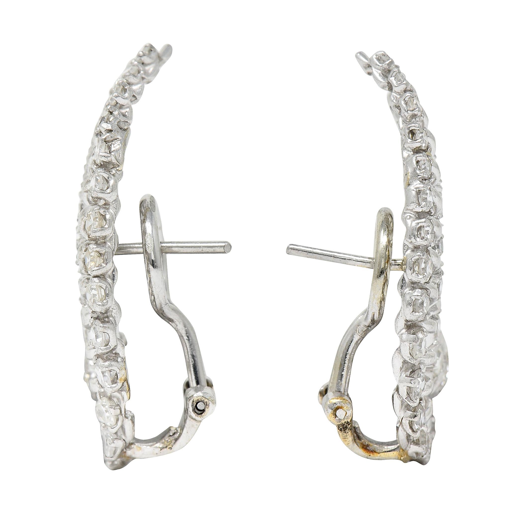 Earrings are designed as curved striated forms that crawl up the ear

Set throughout by single and transitional cut diamonds

Weighing in total approximately 1.50 carats - H/I color with VS clarity

Completed by posts and hinged omega backs - tested