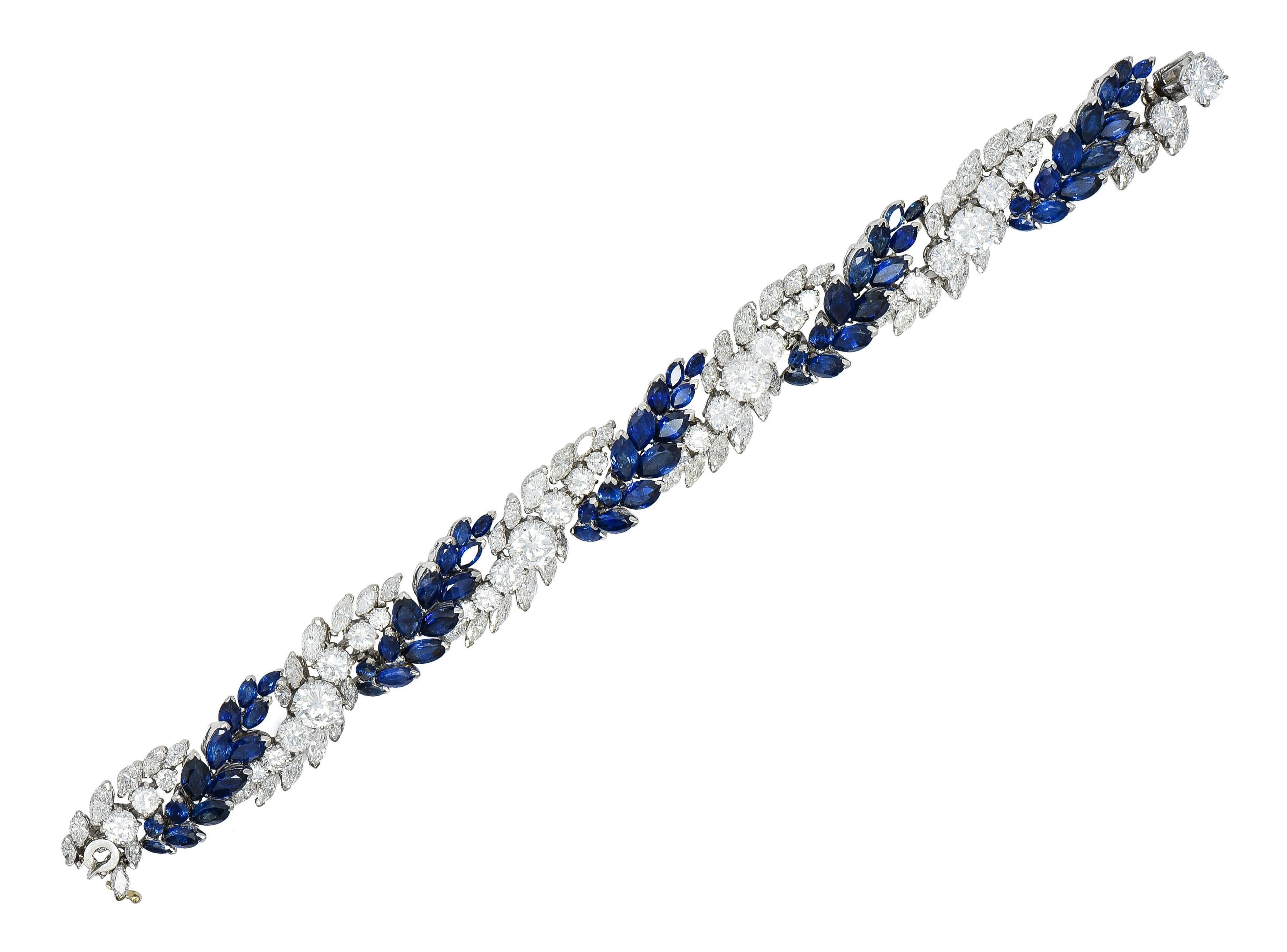 Designed as a twisted foliate motif comprised of alternating rows of diamonds and sapphires 
Featuring five prong set and graduated transitional cut diamonds in middle of twists
Weighing approximately 5.90 carats total - G color with VS2