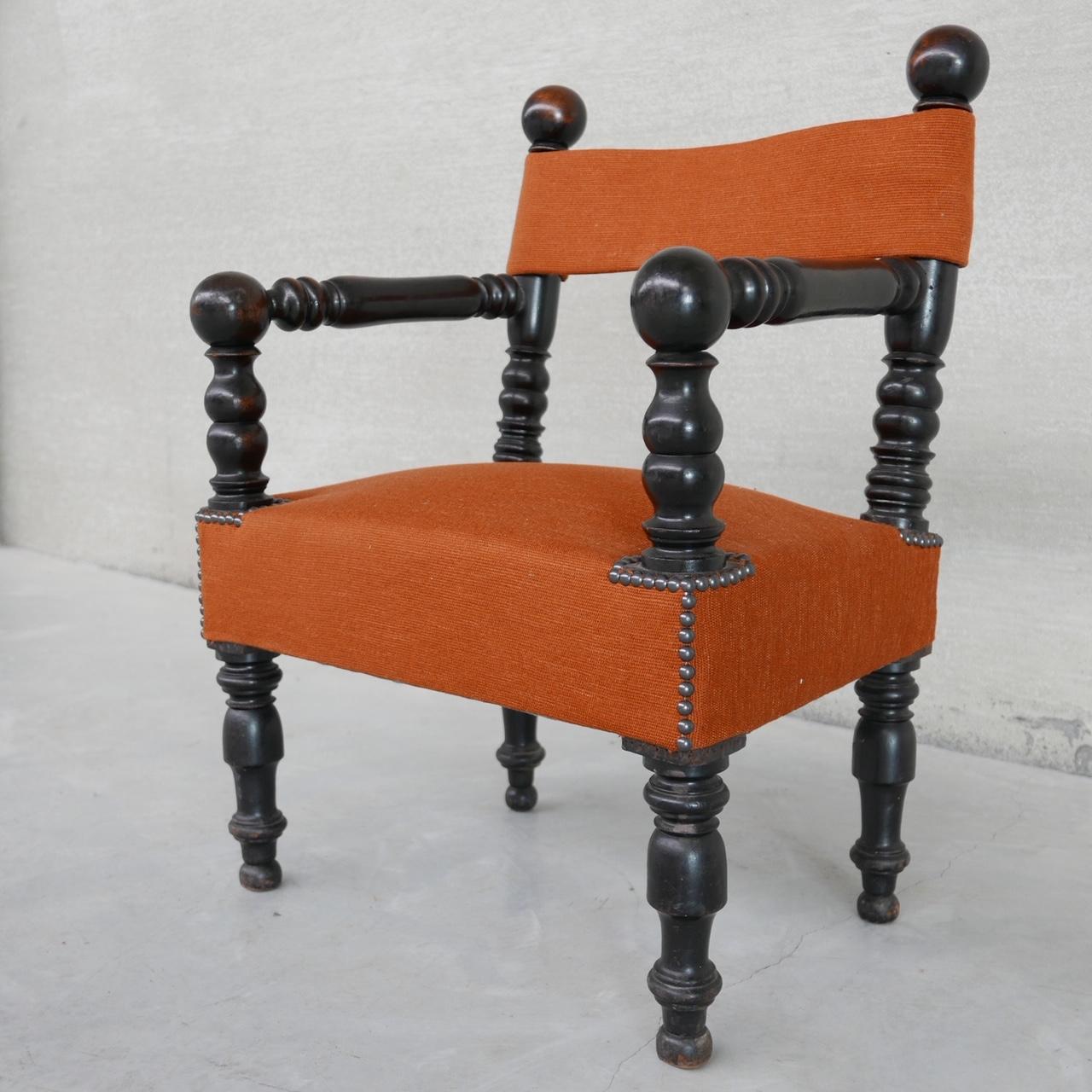 A petite ebonised wooden upholstered armchair.

Orange upholstery remains in great condition. 

France, c1940s. 

In the manner of Dudouyt. 

Location: Belgium Gallery. 

Dimensions: 60 W x 47 D x 40 seat height x 77 total height in