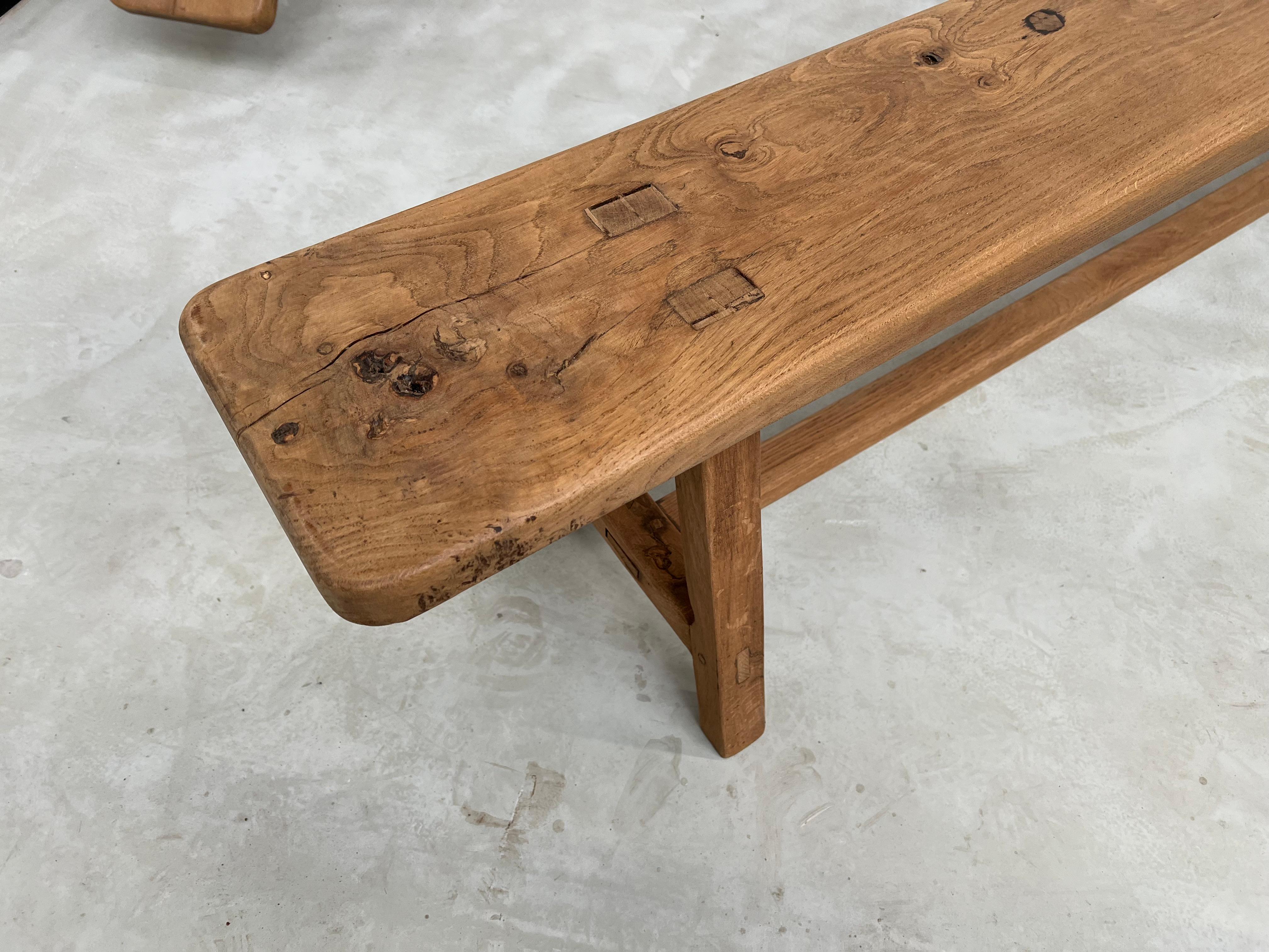 Dating from the 1950s, the work on these two solid oak farm benches is very careful. The restoration carried out by us enhances the veining and patina of the oak wood. Note that one of the two benches does not have a reinforcement bar but that it is