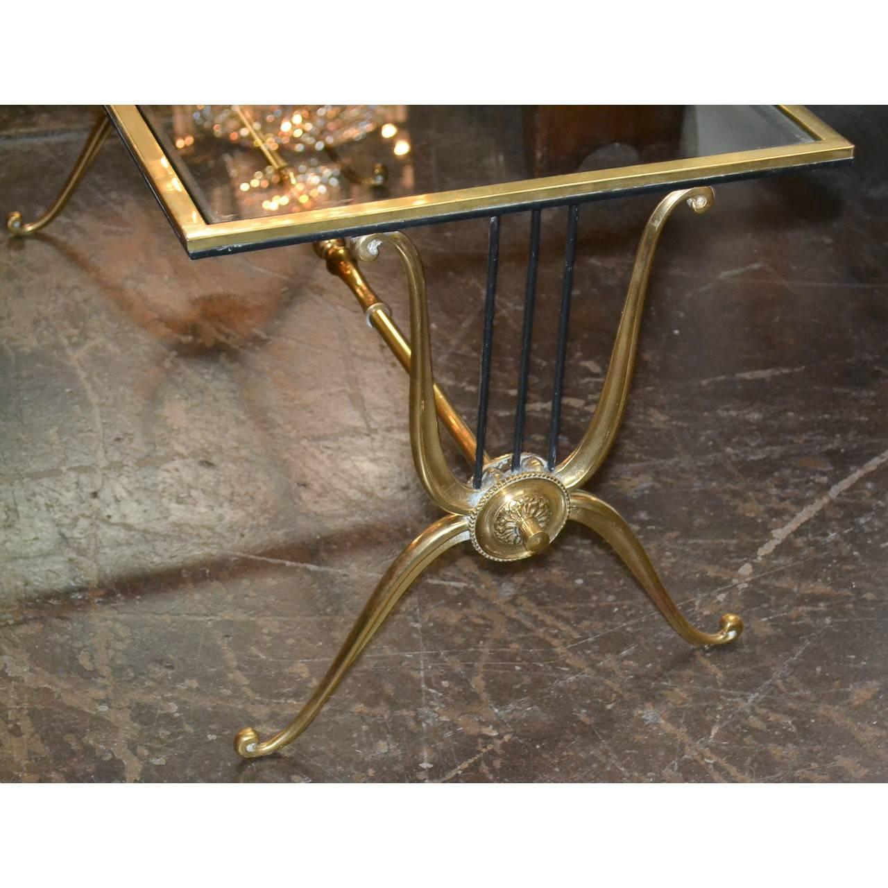Wonderfully styled French Mid-Century Modern glass top rectangular coffee table. The uniquely designed base with polished brass and iron lyre-form ends with turned brass stretcher and nicely contoured legs,

circa 1950

Would mix superbly with a