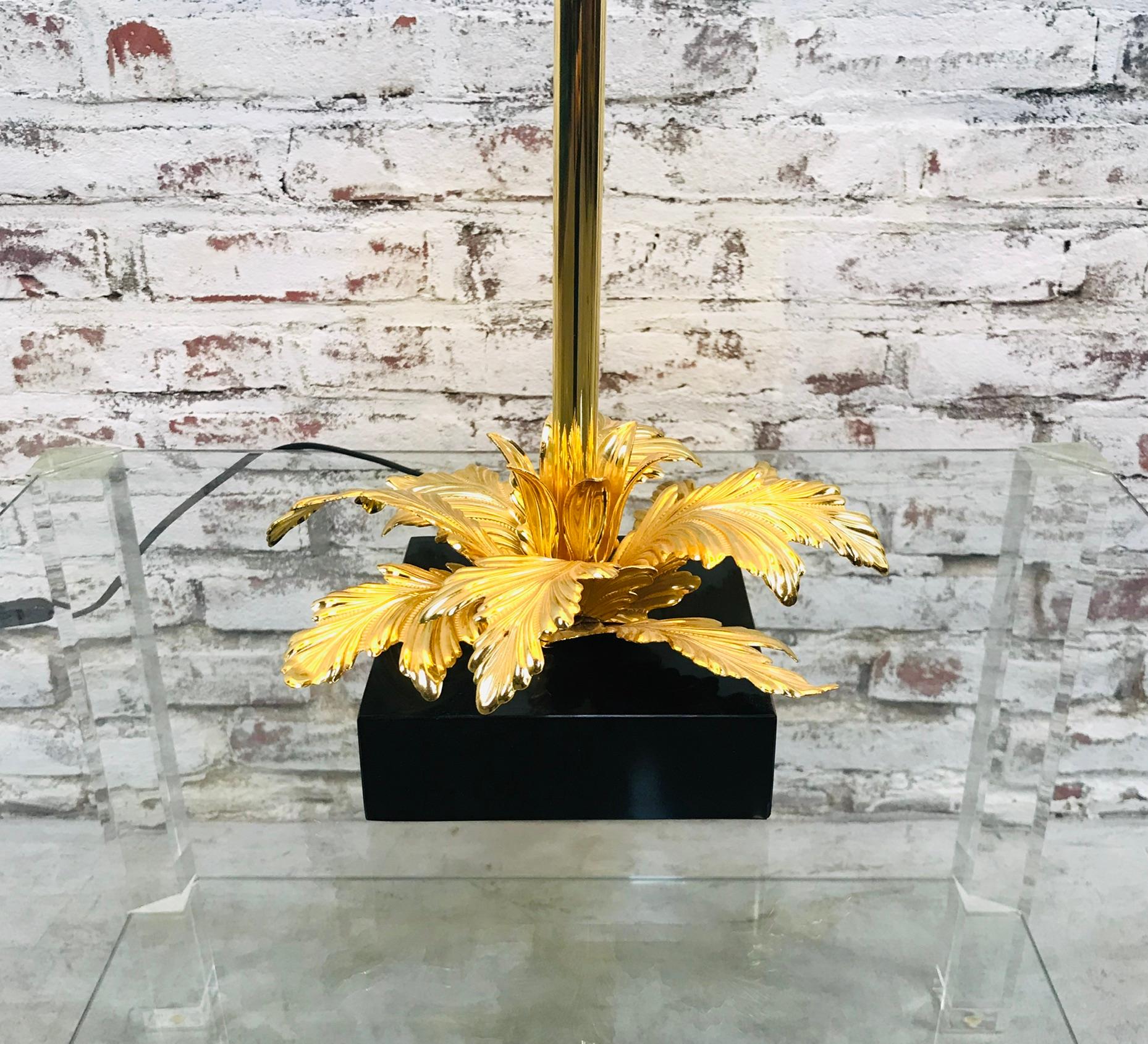 Midcentury table lamp with gold color brass leaves and a square marble foot. The condition is very good.