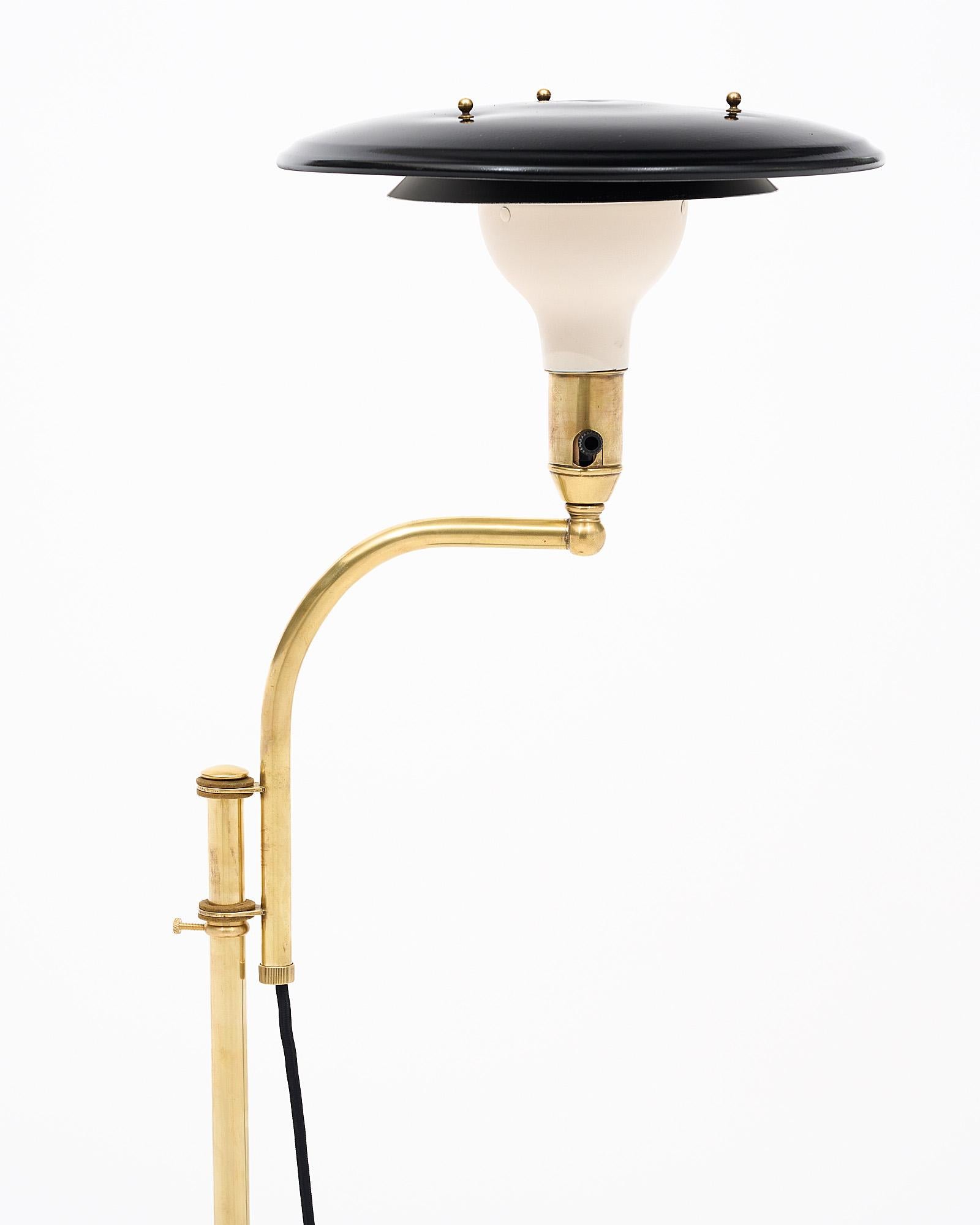 Floor lamp, French, of gilt brass tubular and black lacquered pole.
