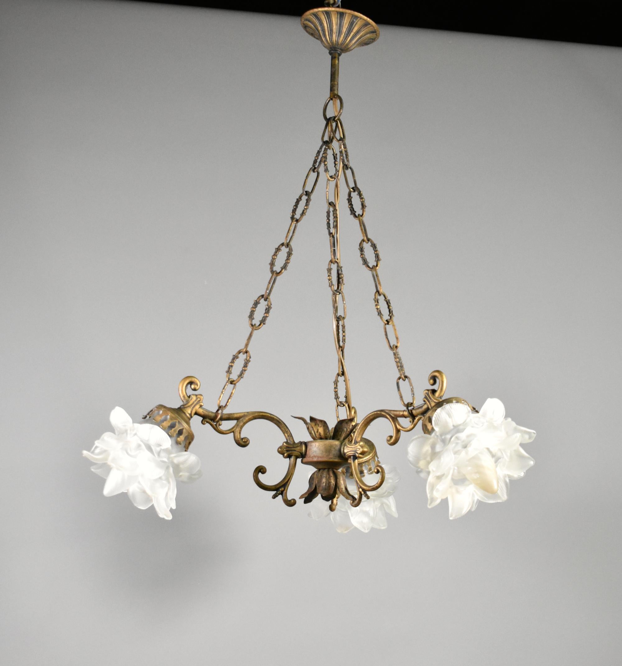 French Mid Century Ceiling Light with Three Floral Shades
 
This delightful French Three Light bronzed ceiling light features three original floral semi-opaque glass shades.
 
The outstretched arms have C-scroll decoration and are joined in the