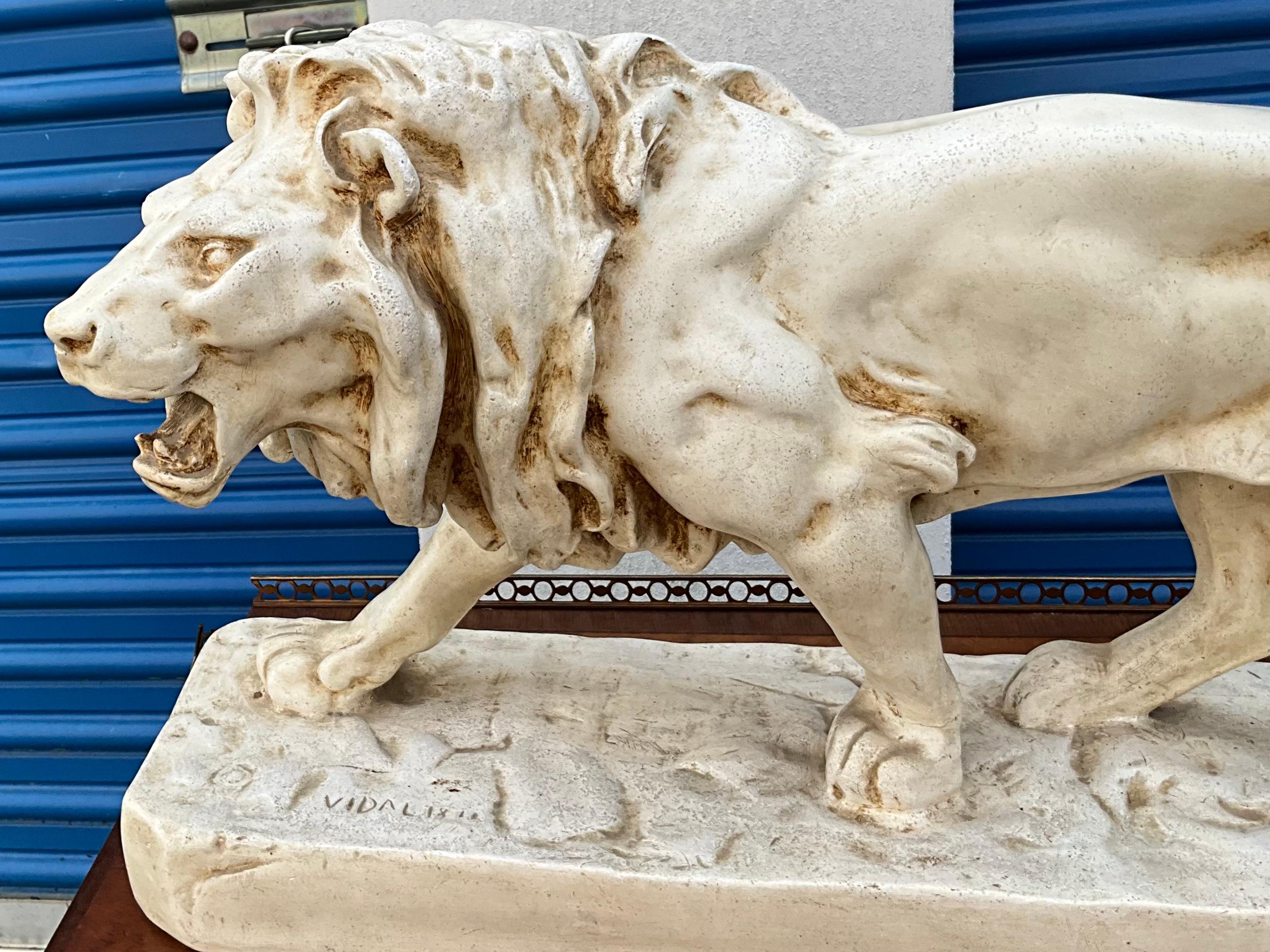 I believe this to be a mid-century cast ceramic interpretation of the work created by French sculpture, Louis Vidal, c. 1831-1892. It is a striding lion and a majestic piece!
   