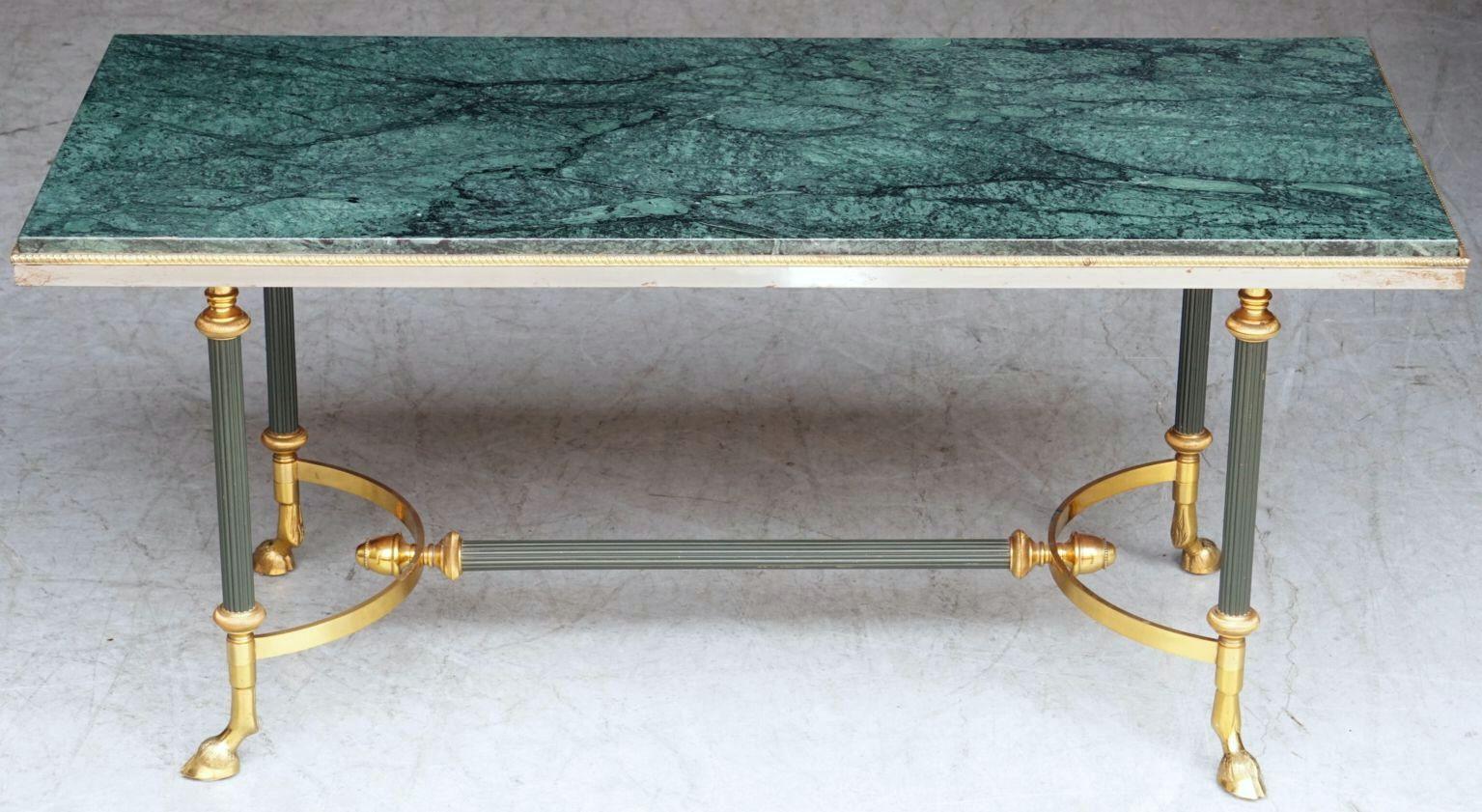 A fine French Mid-Century coffee or cocktail low table of brass and marble attributed to the Parisian interior decoration and design house of Maison Jansen, featuring a rectangular top of figured green marble set into a gilt frame, over a frame of