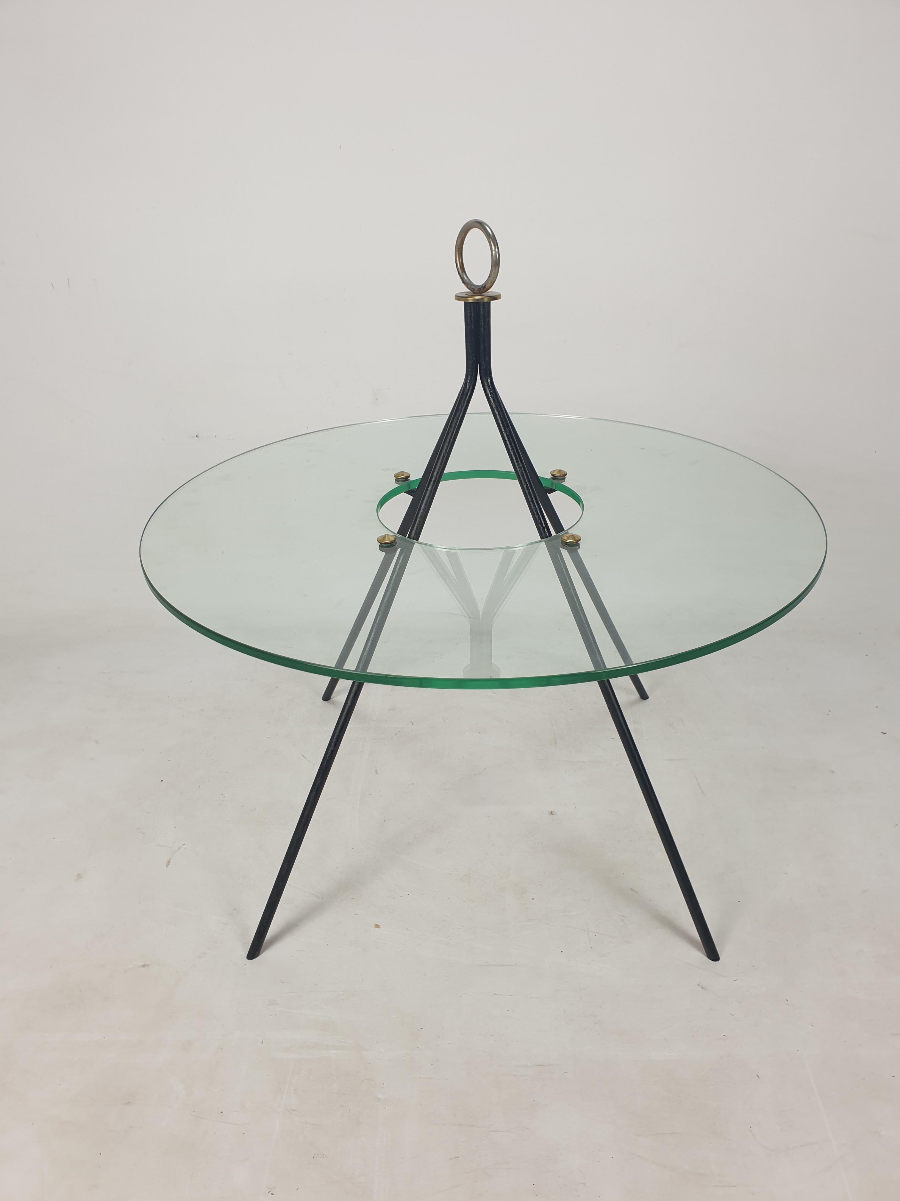 Rare and very nice round coffee table by Claude Delor.
This stunning French piece is designed and fabricated in the 50's.

4 steel legs with a round glass plate and brass screws.

The glass is in very good condition.