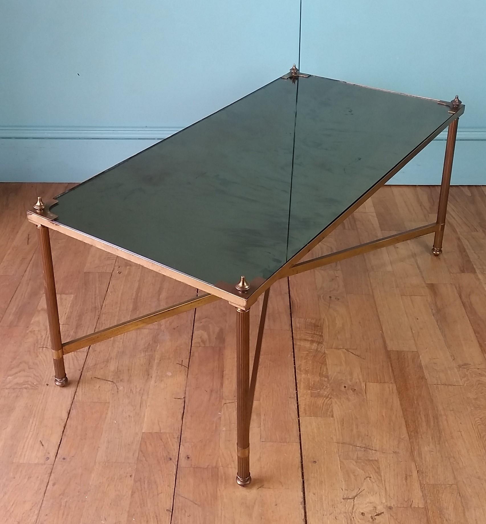 Mid century French coffee table by world famous Paris design house Maison Jansen.
Beautiful timeless design in authentic vintage condition with original bronzed etoile mirrored glass top.
The brass has taken on that lovely time worn patina and