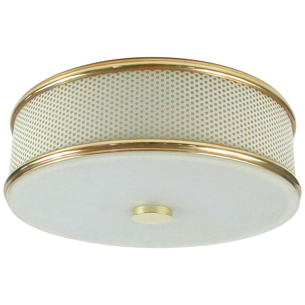 This stylish perforated flush mount / light fixture was designed and manufactured in France in the 1950s. Since the French designer Mathieu Matégot preferred to work with perforated metal this became very popular.

The light is partially restored,