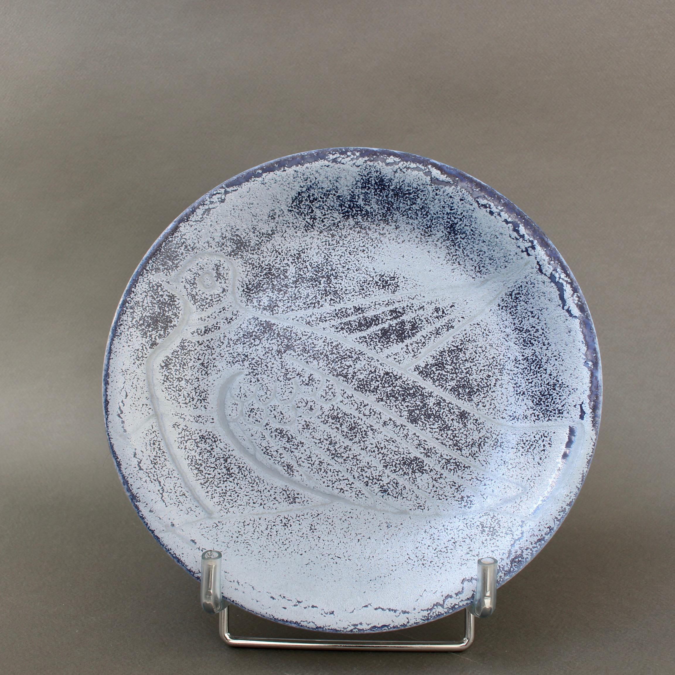 Mid-century decorative plate by ceramicist, Roger Capron (circa 1960). Iridescent blue with an incised dove, this is a Capron style rarely available. The dove has been a symbol of peace for centuries. Picasso famously created a very limited edition