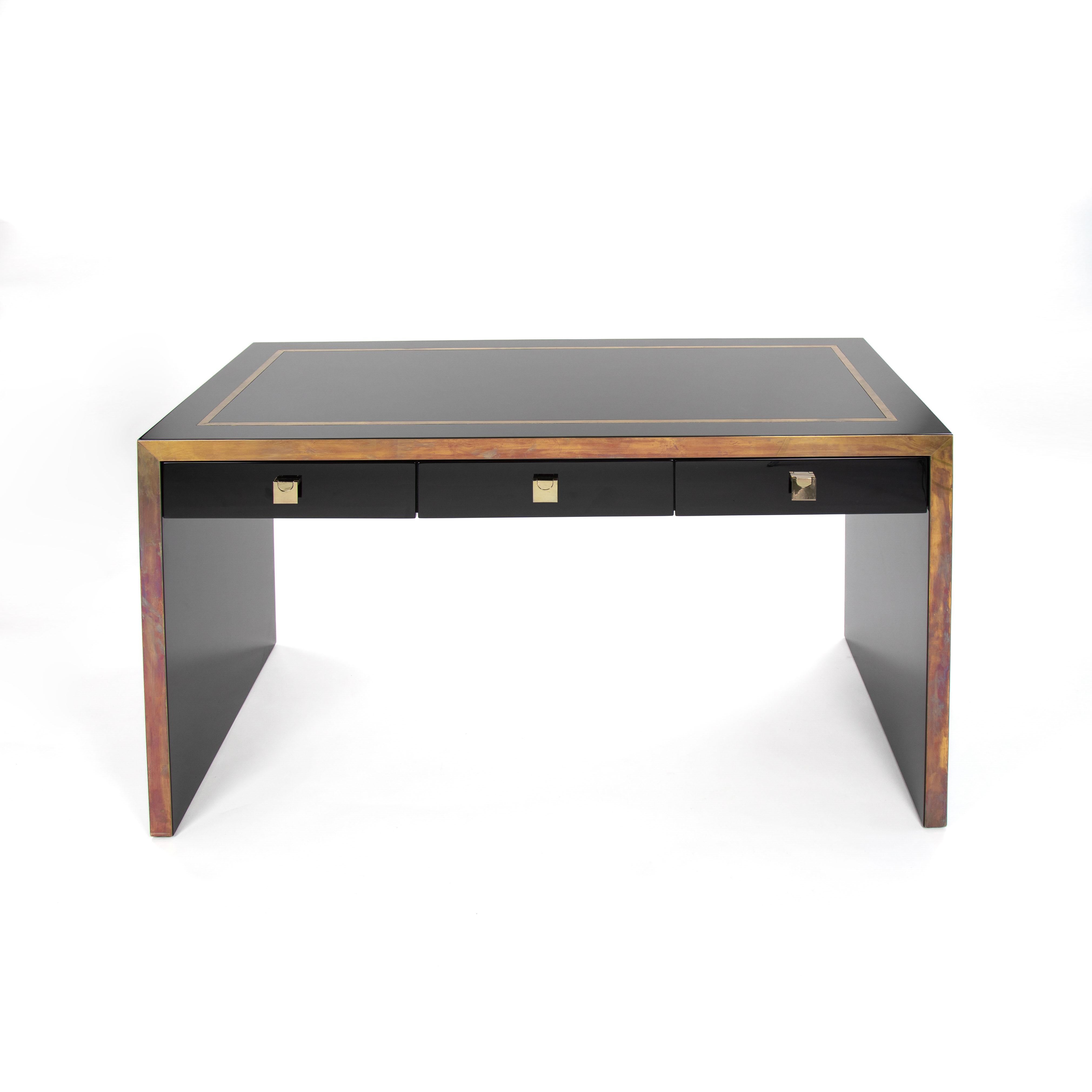 Straight-lined desk in a clear design by French designer Jean Claude Mahey.

The object is made entirely of beech wood and is very heavy.
The desk has 3 drawers with folding brass handles.
The top plate has an all-round brass inlay decoration that