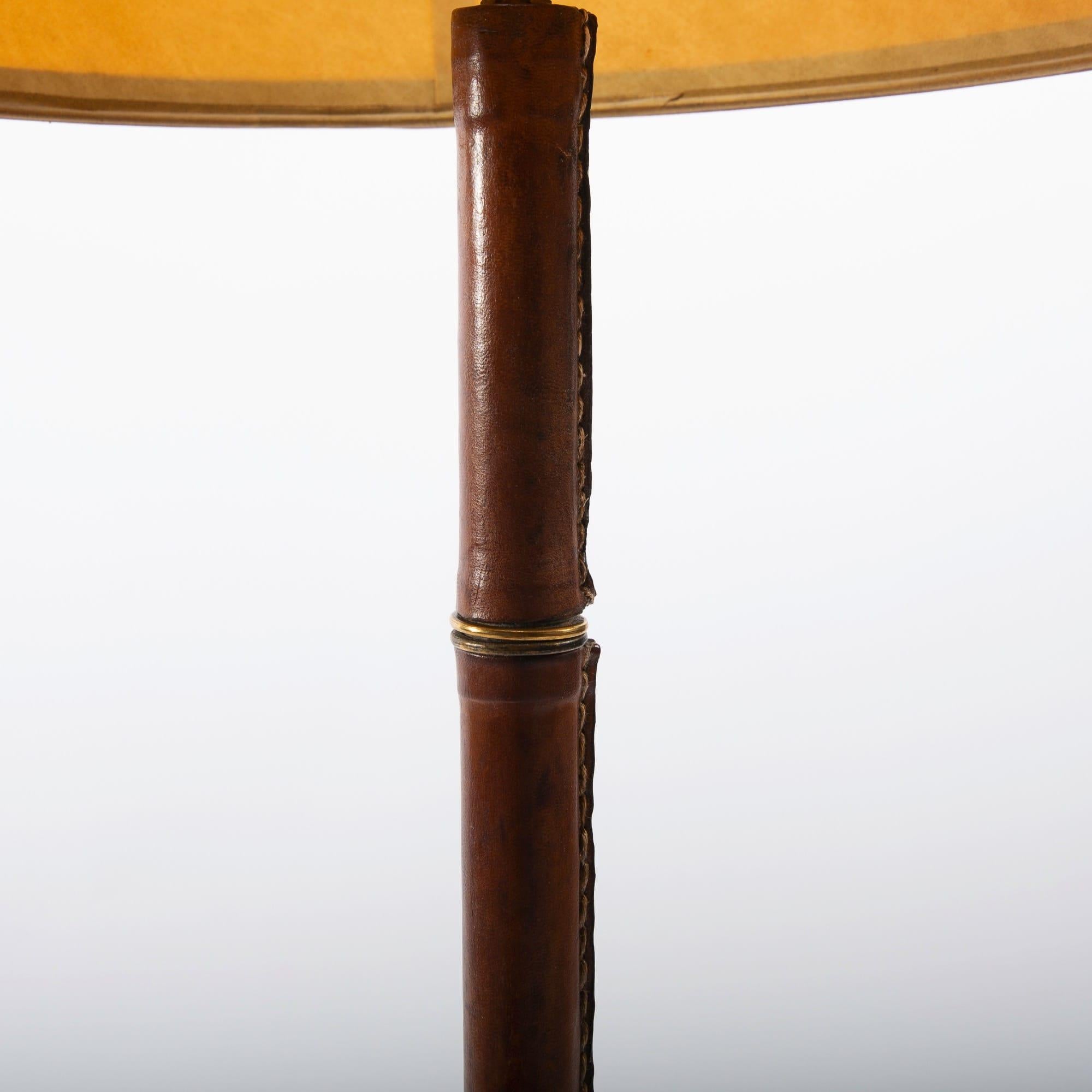 A desk lamp Jacques Adnet (France) circa 1950.
Beautiful saddle stitched tan leather work on a steel frame with brass accents
Original lampshade with leather hem.

Jacques Edouard Jules Adnet was born in Châtillon-Coligny France in 1900 and died