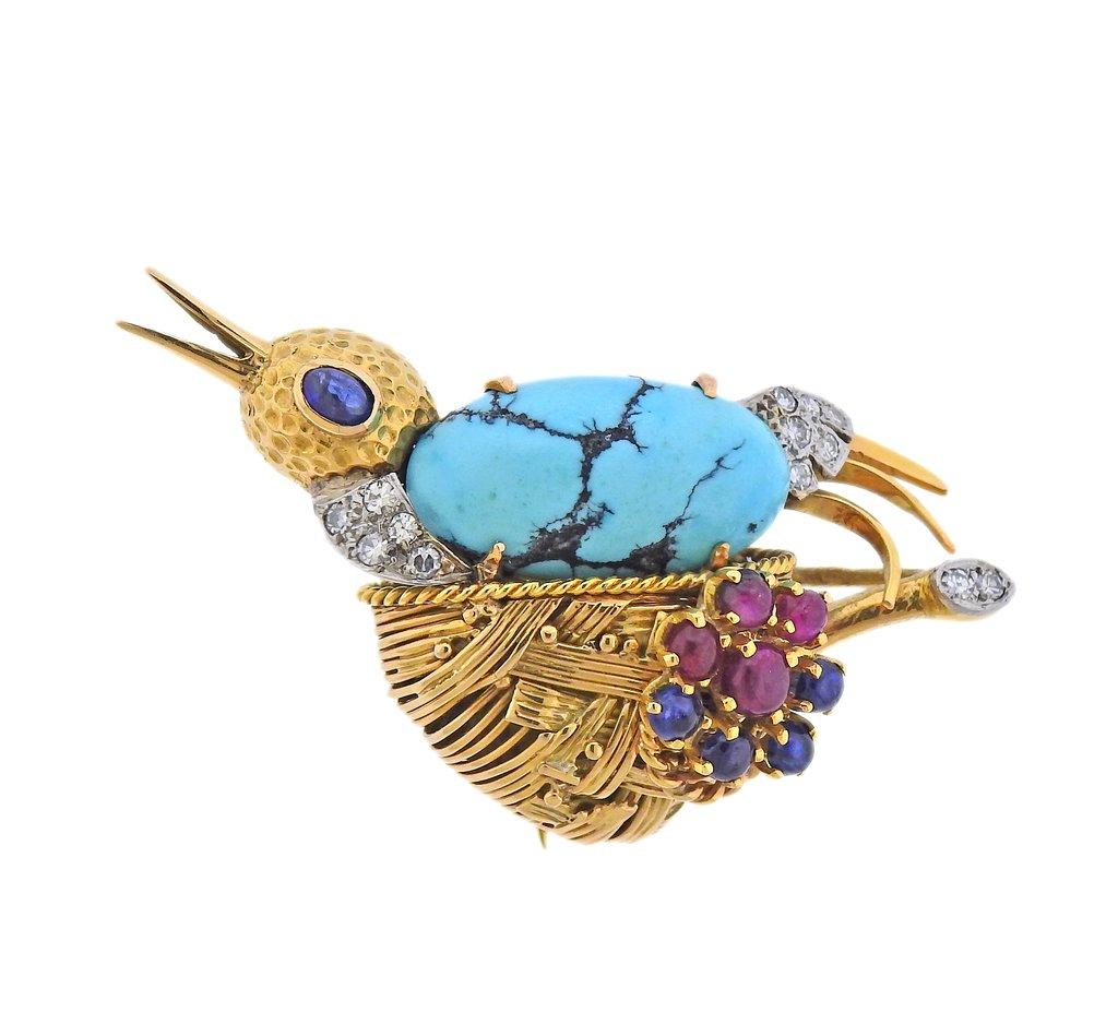 Made in France, 18k gold bird's nest brooch, decorated with rubies, sapphires, turquoise and approx. 0.35cts in diamonds.  Brooch is 57mm x 33mm. Marked: French eagle punchmarks. Weight - 22.3 grams. 