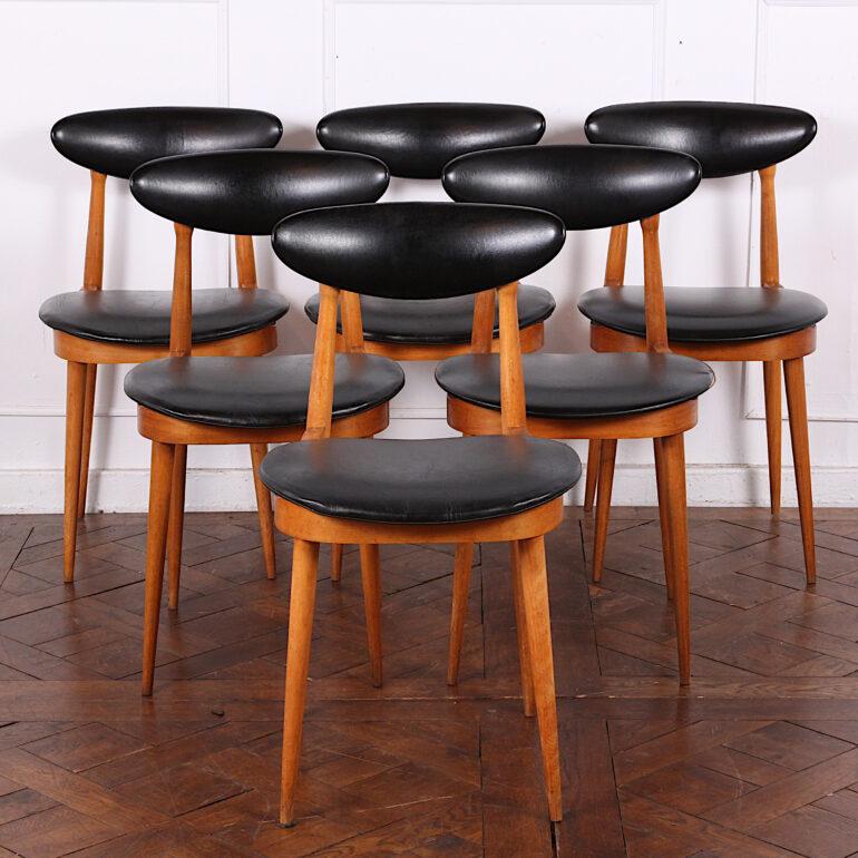 A set of six French mid century beech wood-framed dining chairs designed by Pierre Guariche.