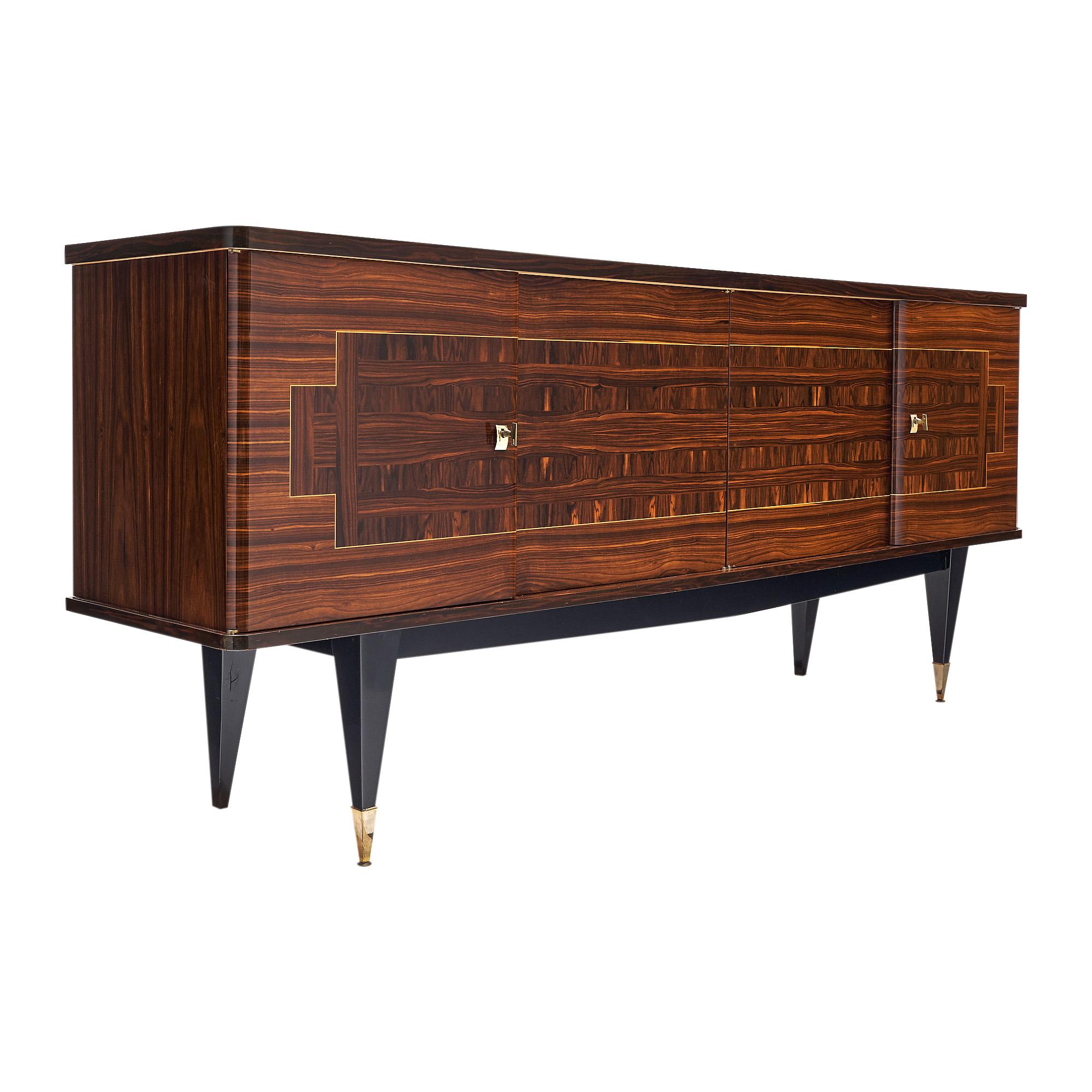 French buffet, enfilade, of rosewood and ebony of Macassar. We loved the Intricate Parquetry on the façade of this spectacular credenza. The four doors open up to a satin wood interior with shelves and drawers. Tapered legs with brass feet and with
