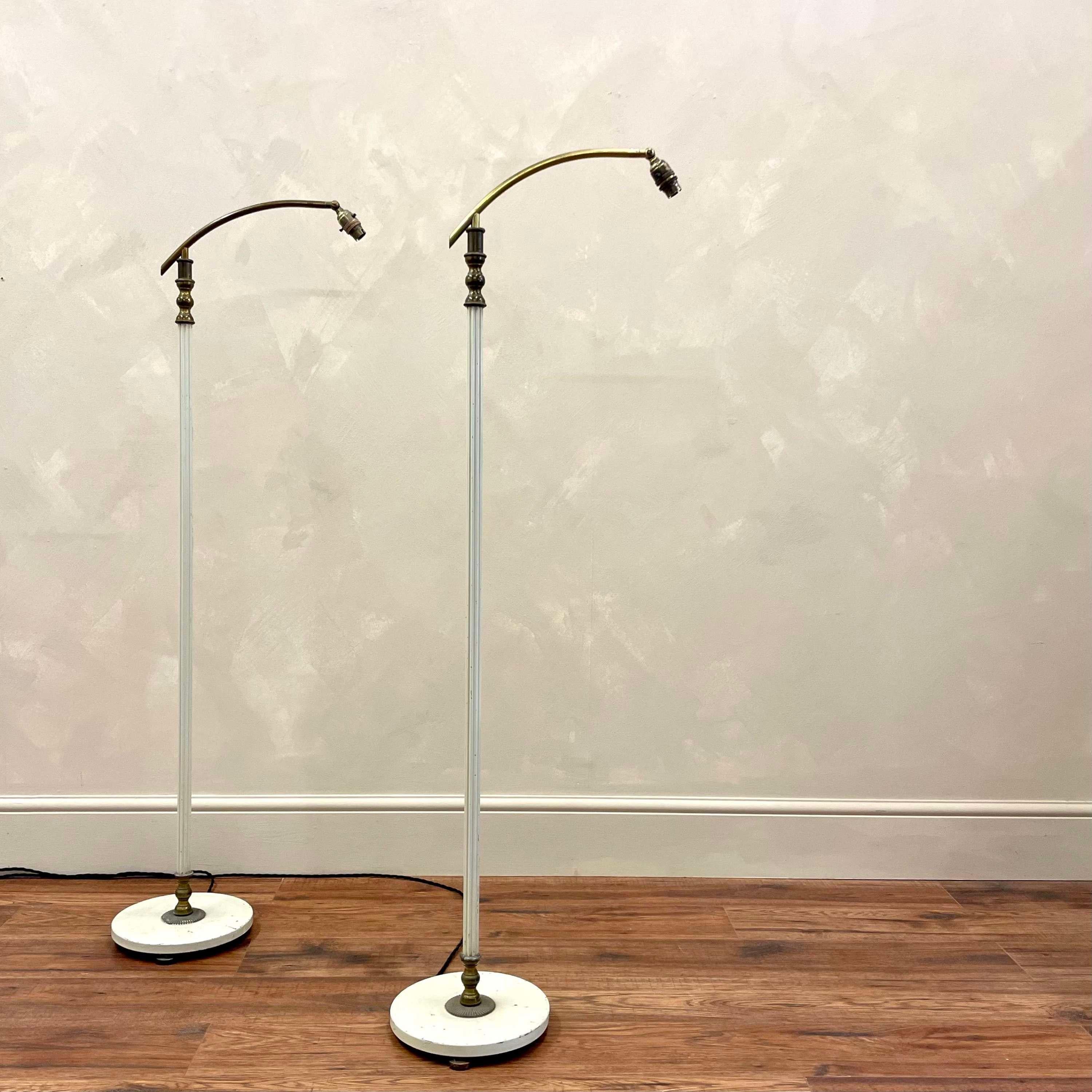 Pair of French mid century standard lamps.
With off white reeded stems leading to curved brass bulb arms. 
Extendable heights from 135cm to 163cm.
Newly wired and PAT tested.
Dimensions:H: 163cm (64.2