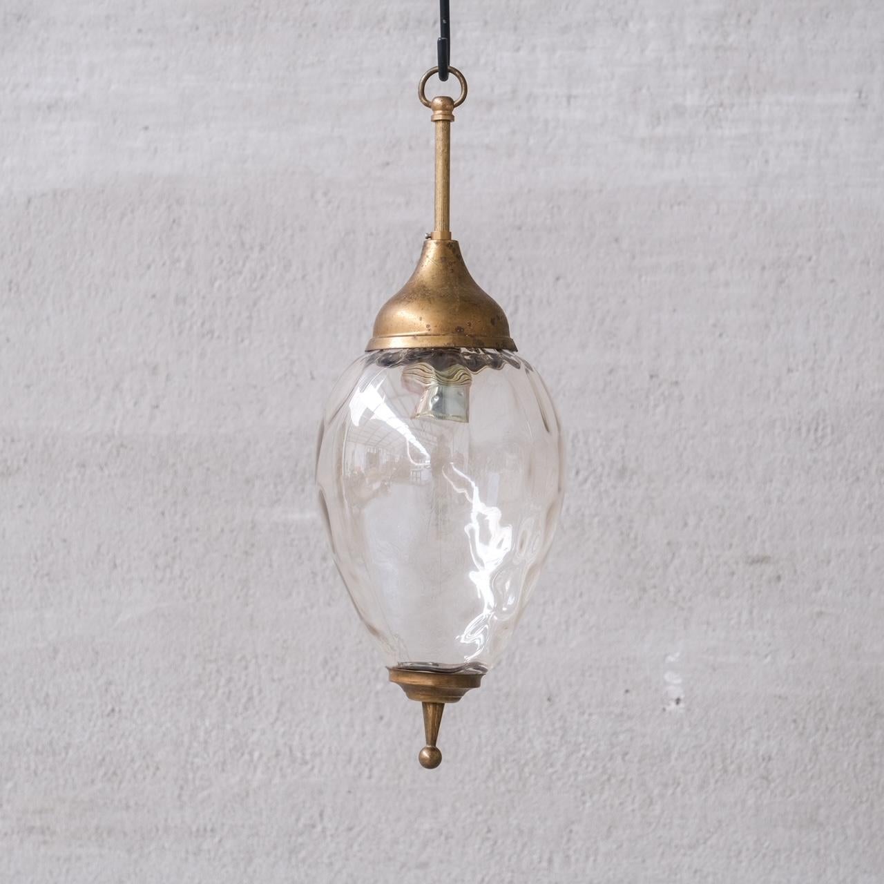 Brass and undulating glass pendant light.

France, c1950s.

Natural patination and aging to the brass.

No chain or ceiling rose was retained, we can recommend where to source.

Good vintage condition, some scuffs and wear commensurate with