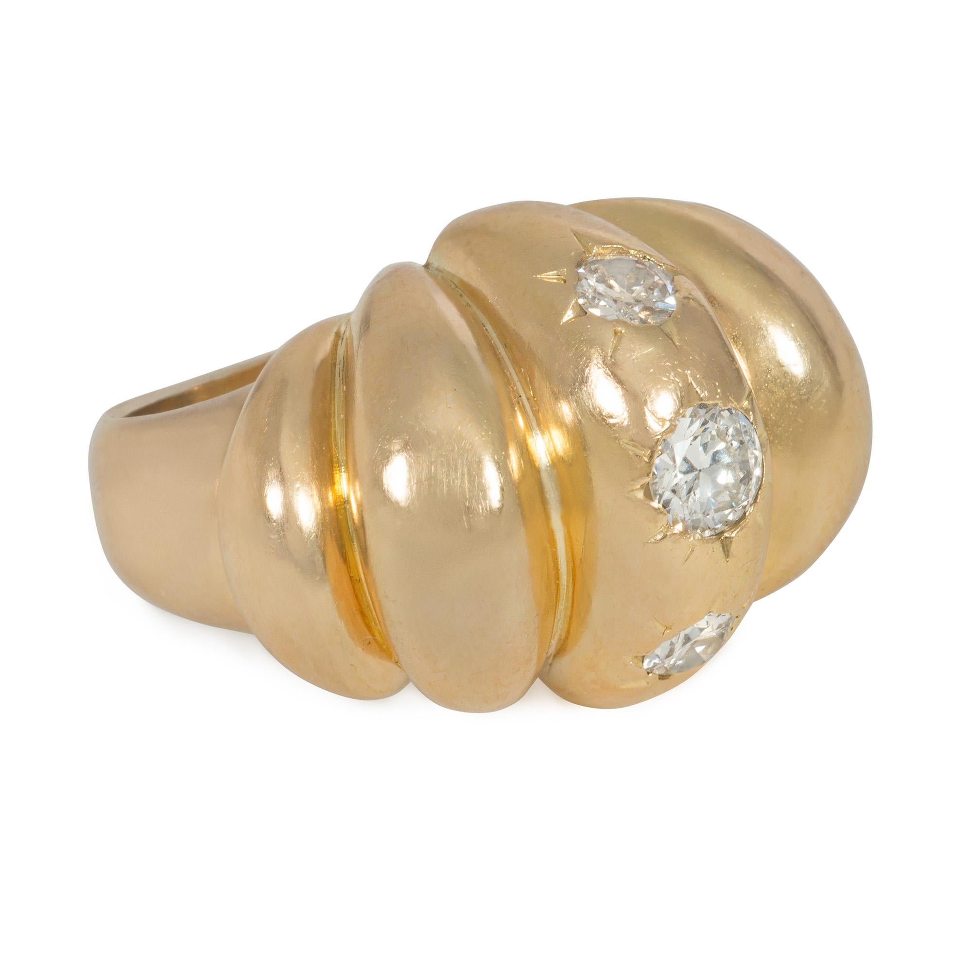 A Mid-Century gold and diamond bombé cocktail ring of lobed design, centered by three round brilliant-cut in-set diamonds, in 18k.  France.  Atw 0.75 ct.
Face-up north to south measurement: 0.75