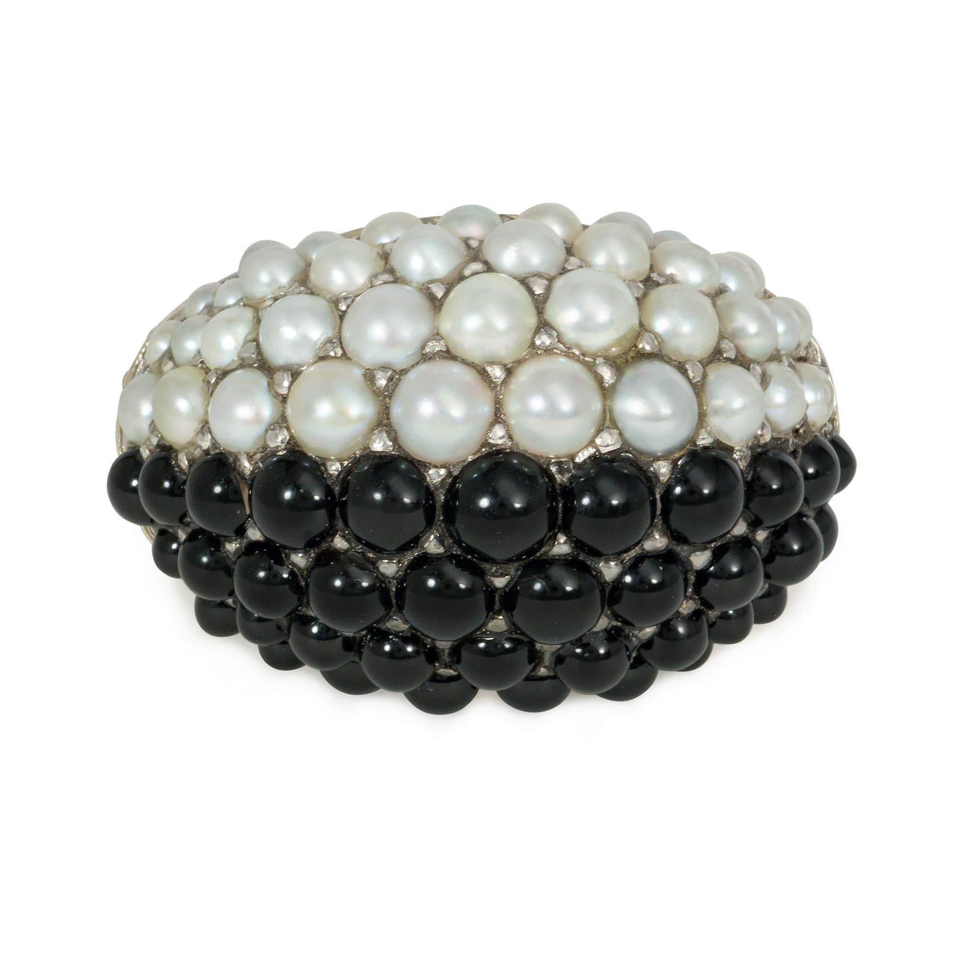 A mid-century gold, pearl, and onyx bombé style ring, one half set with pavé pearls, the other half set with pavé onyx, completed by a tapering ribbed shank, in 18k gold. France.  Face up: 11/16